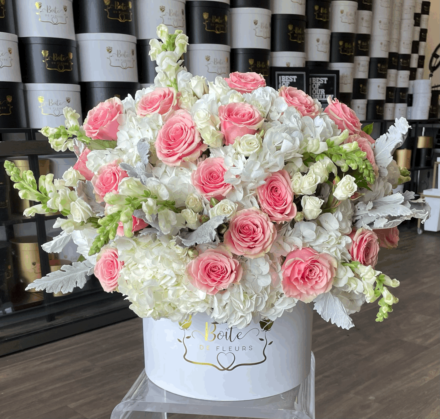 Large pink and white rose arrangement in a white hat box