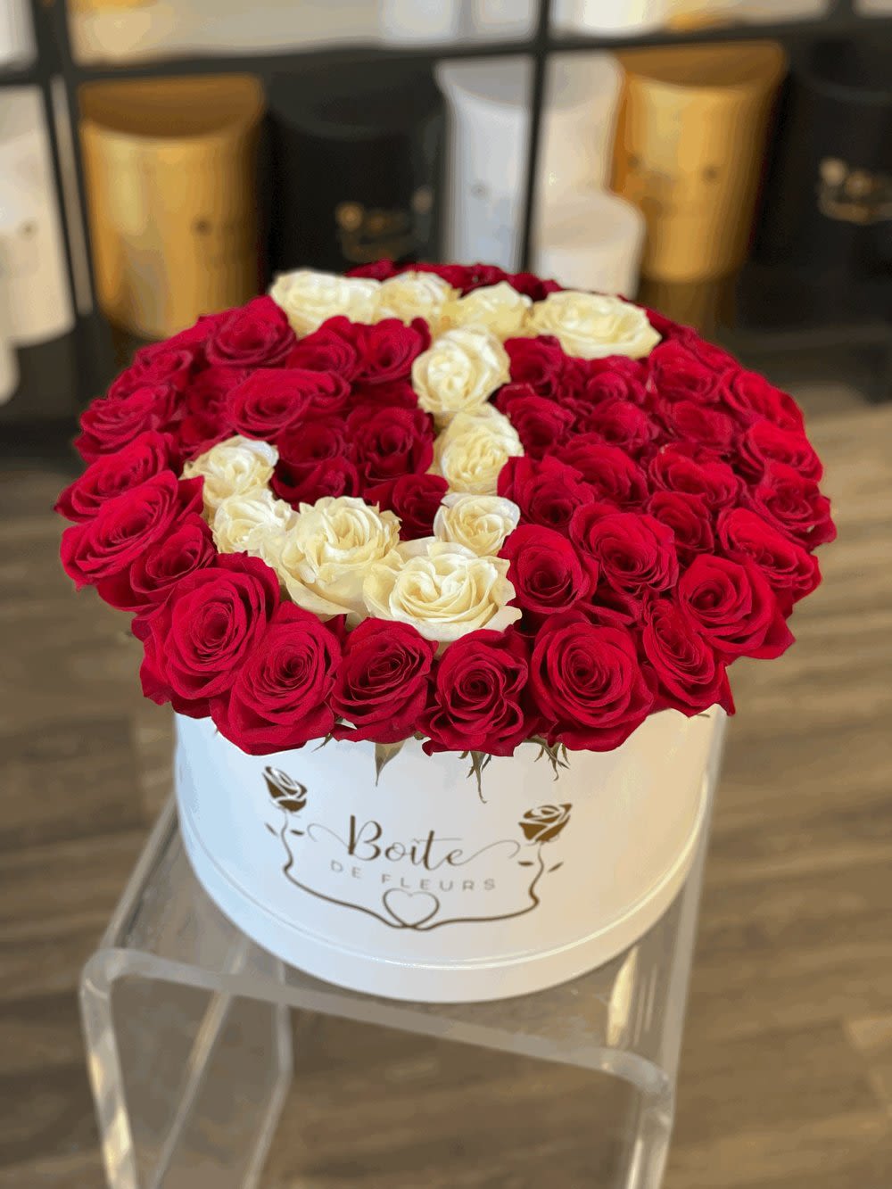 Round box of red and white roses arranged in a heart pattern