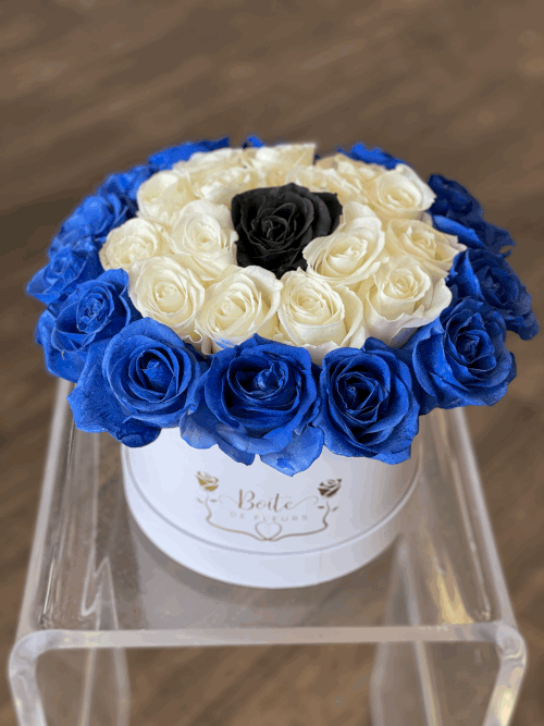 Round box of blue, white, and black roses