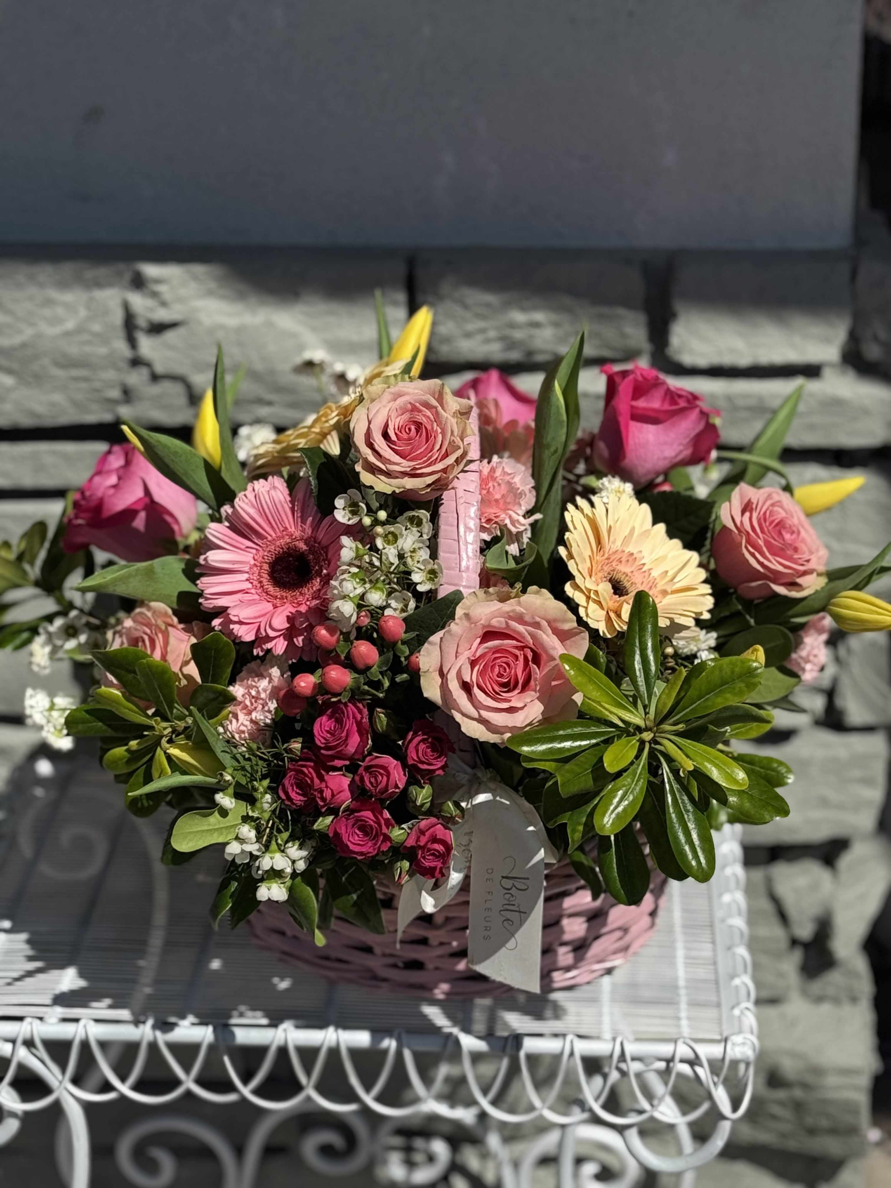 Pink rose and gerbera daisy bouquet in a pink basket