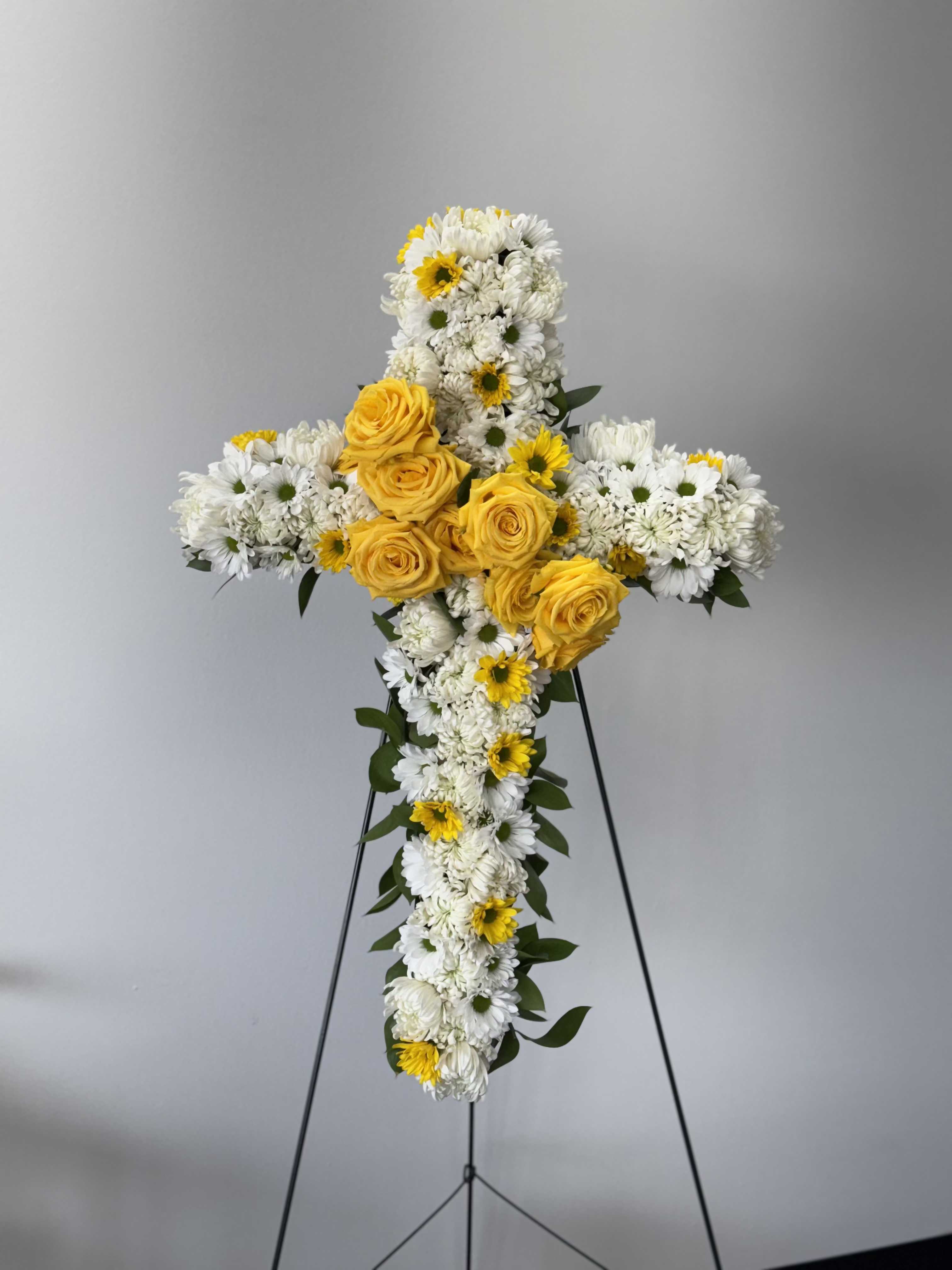 White and yellow floral cross on a stand