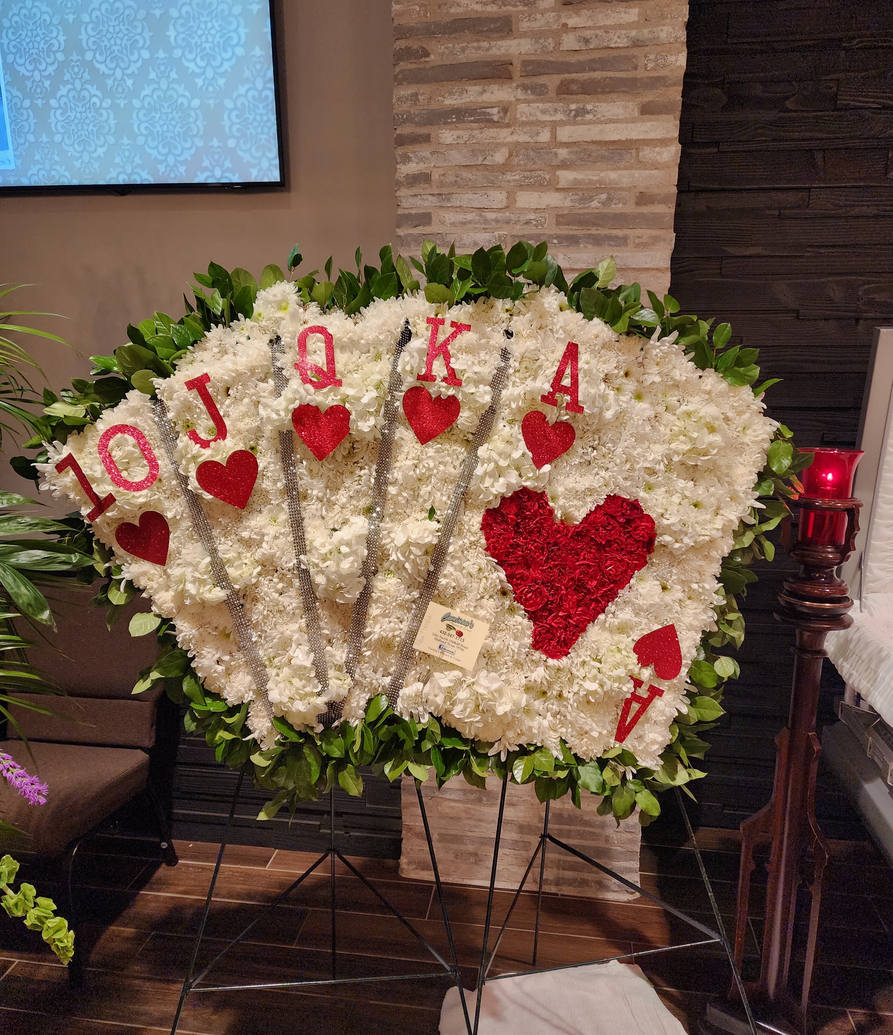 Playing Cards Tribute  - White carnations, poms, white hydrangeas, red carnations, and greenery.   