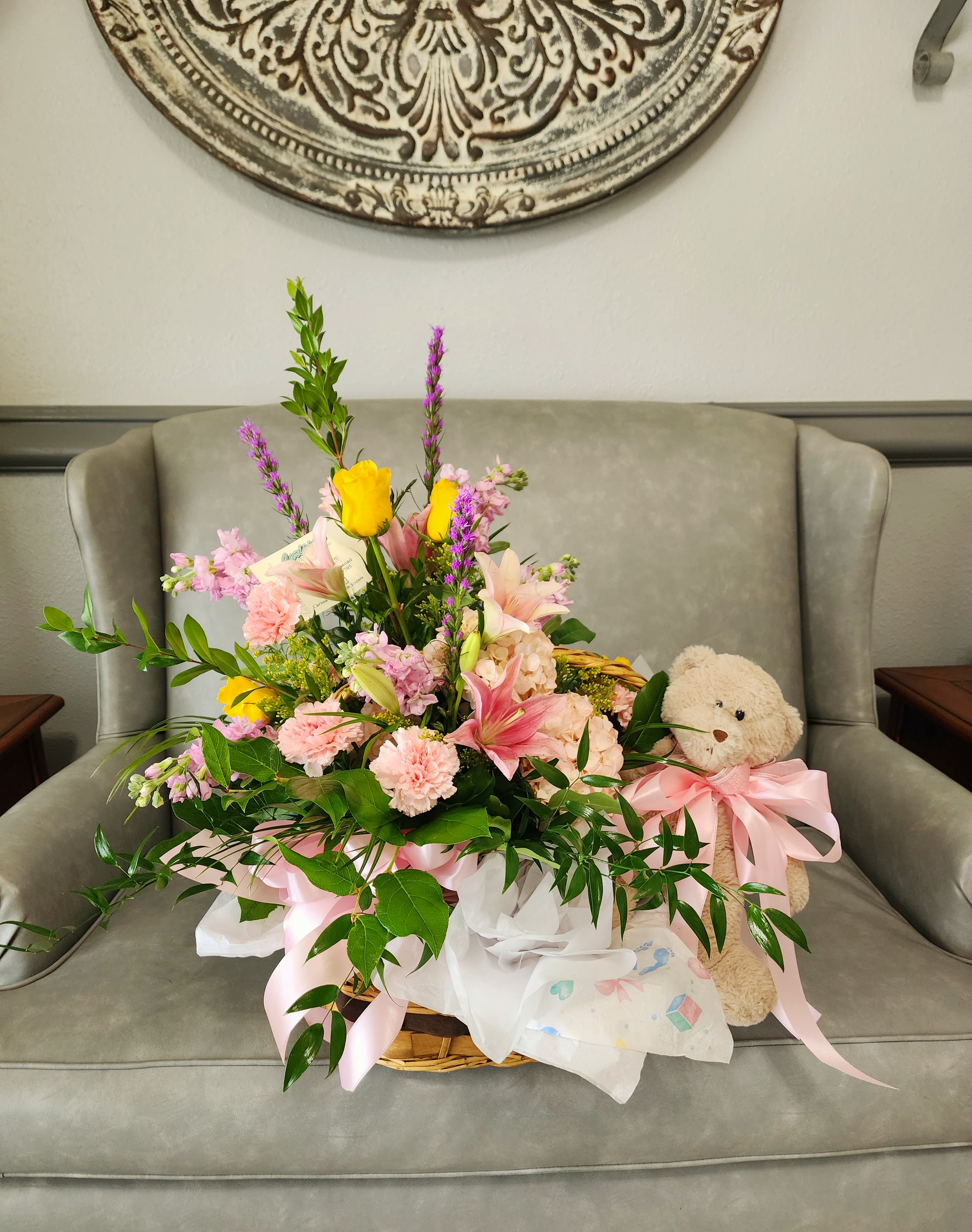 Angel in Heaven - Pink carnations, roses, lilies, greenery, and bear in a basket.