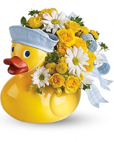 Yellow duck-shaped container with yellow roses and white daisies accented with blue ribbon