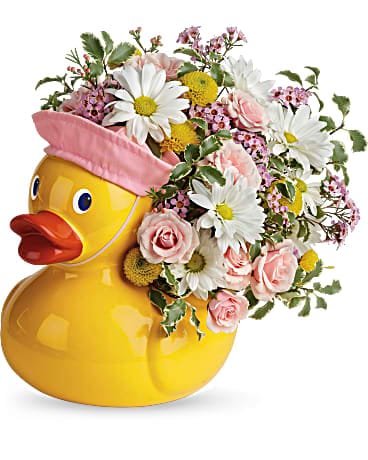Playful arrangement of pink and white flowers in a yellow ceramic duck container with a pink cap.