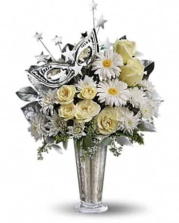 White and cream roses and daisies in a tall silver vase with a silver masquerade mask decoration