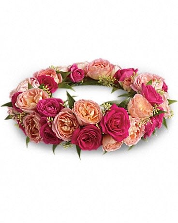 Pink and peach rose wreath arranged in a low circular ring