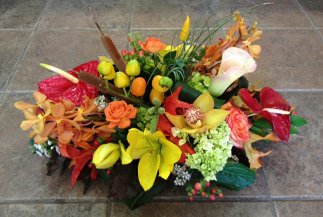Colorful floral arrangement with calla lilies, roses, and orchids