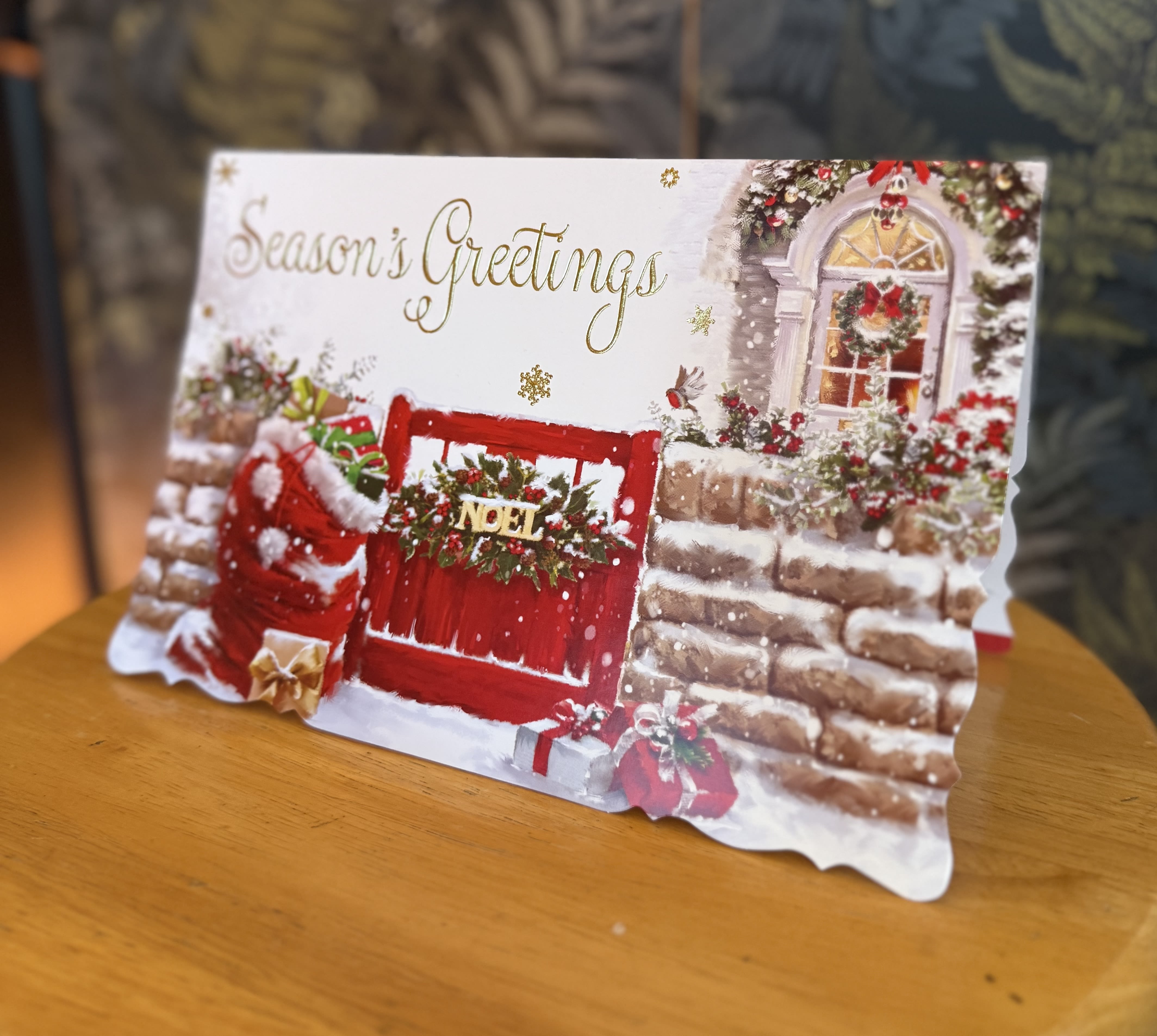 A Christmas greeting card with a red door and holiday decorations