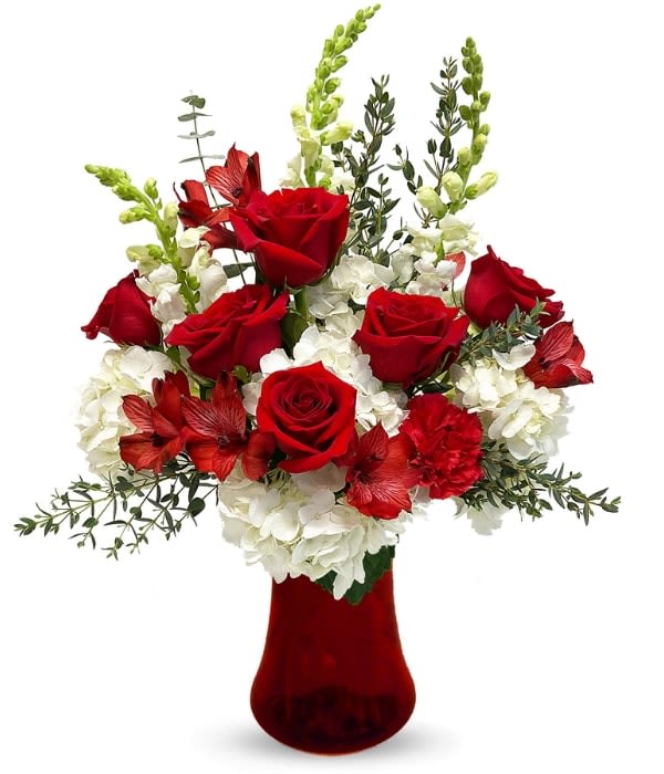 Red roses and white flowers arranged in a red vase