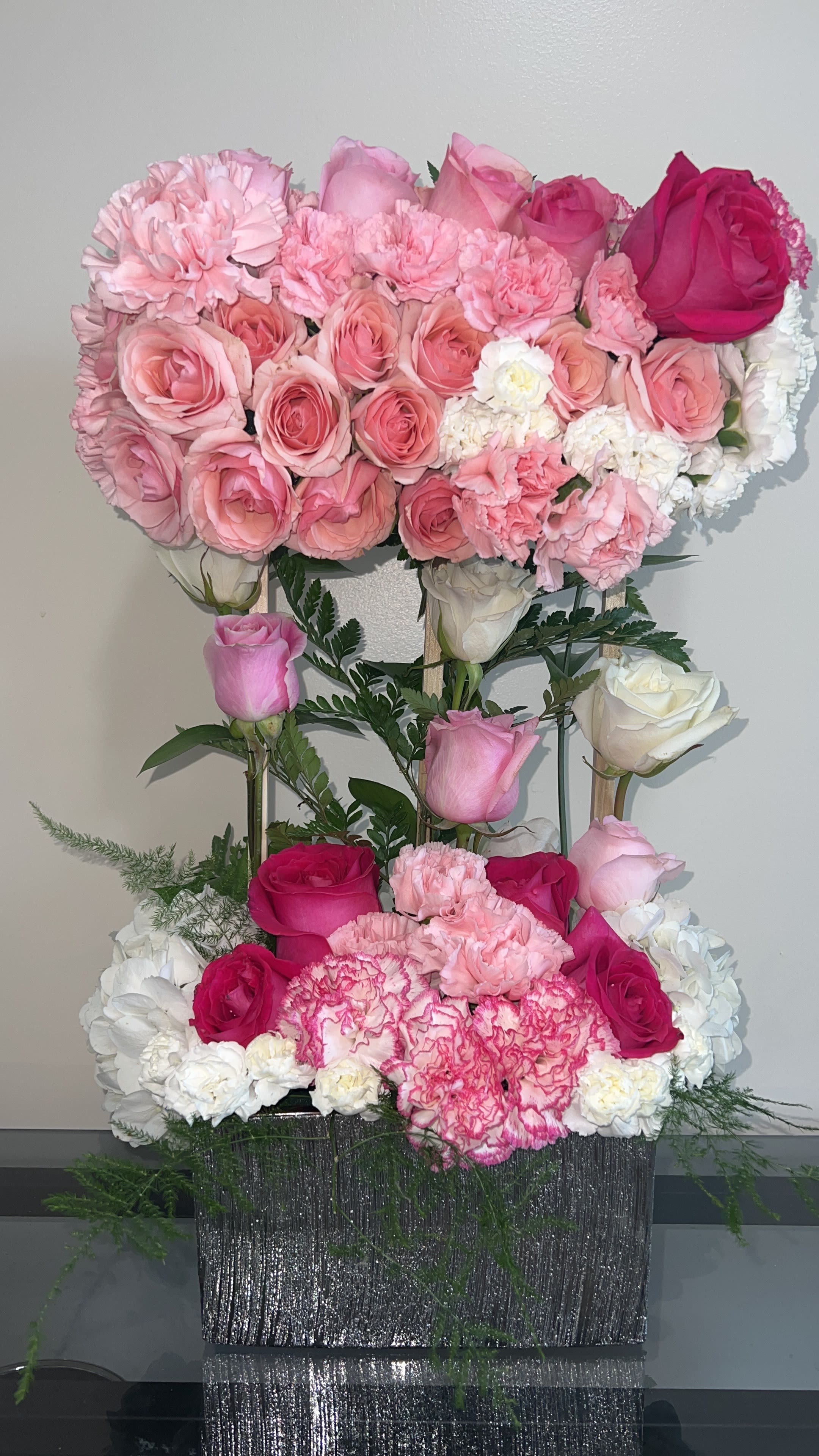 Pink and white rose arrangement in a glittery rectangular container