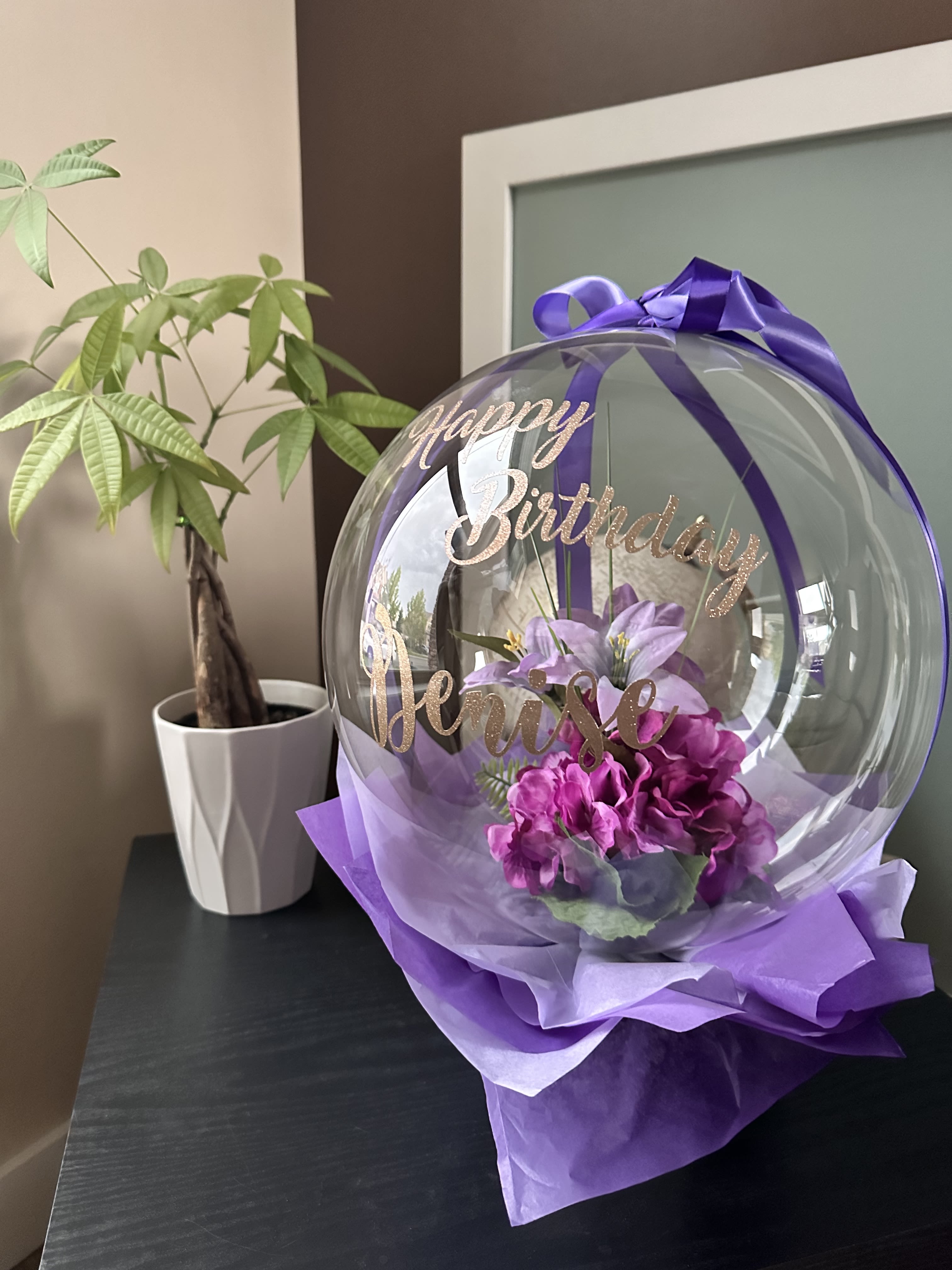 Purple birthday balloon with flowers and ribbon