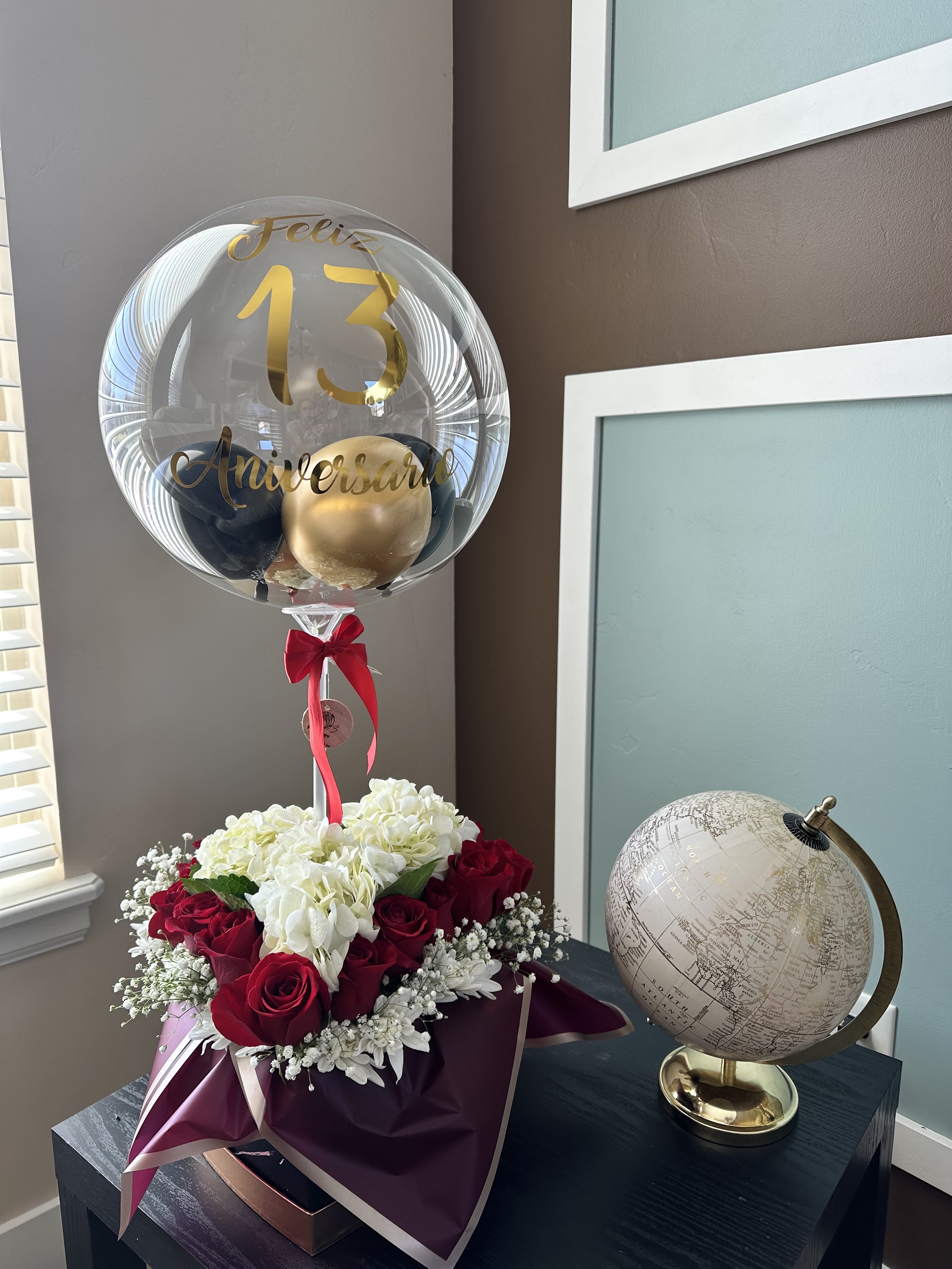 Red roses and white hydrangeas with a clear anniversary balloon