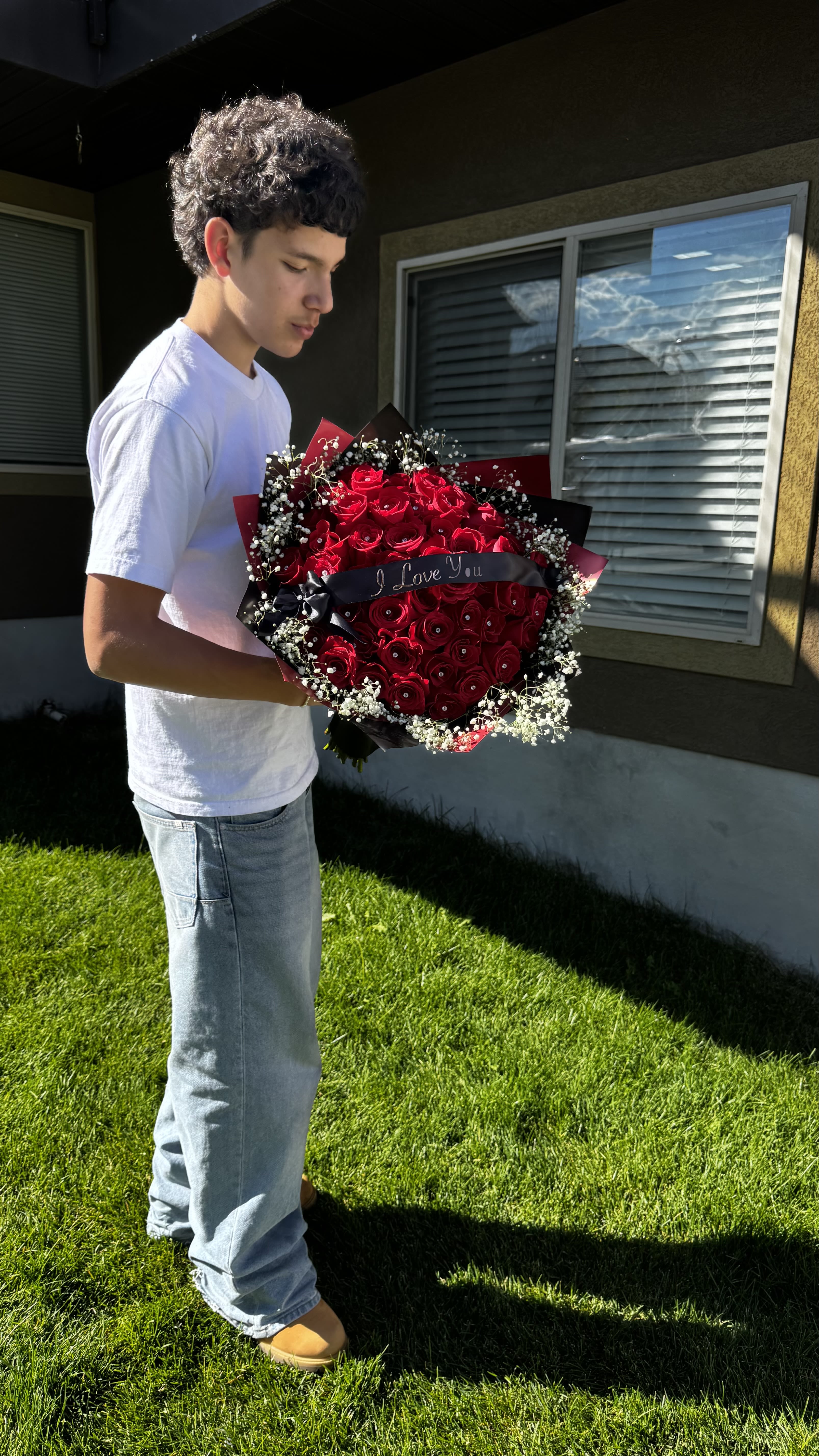 Large bouquet of red roses with baby's breath and a ribbon
