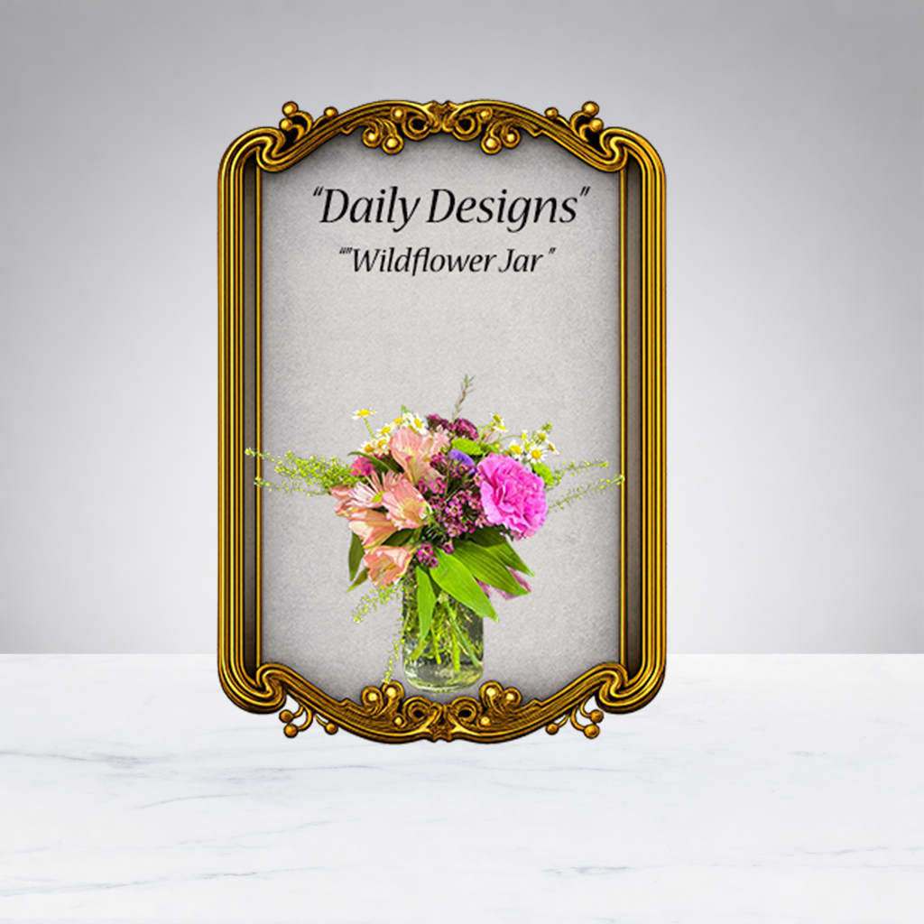 Mixed pink and peach flowers in a clear glass jar