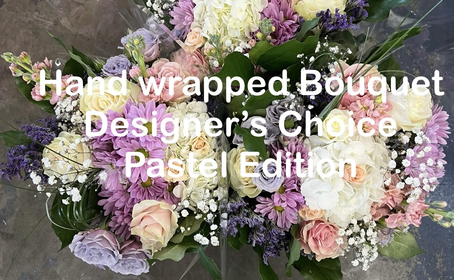 Hand wrapped pastel bouquet with roses, hydrangeas, and daisies