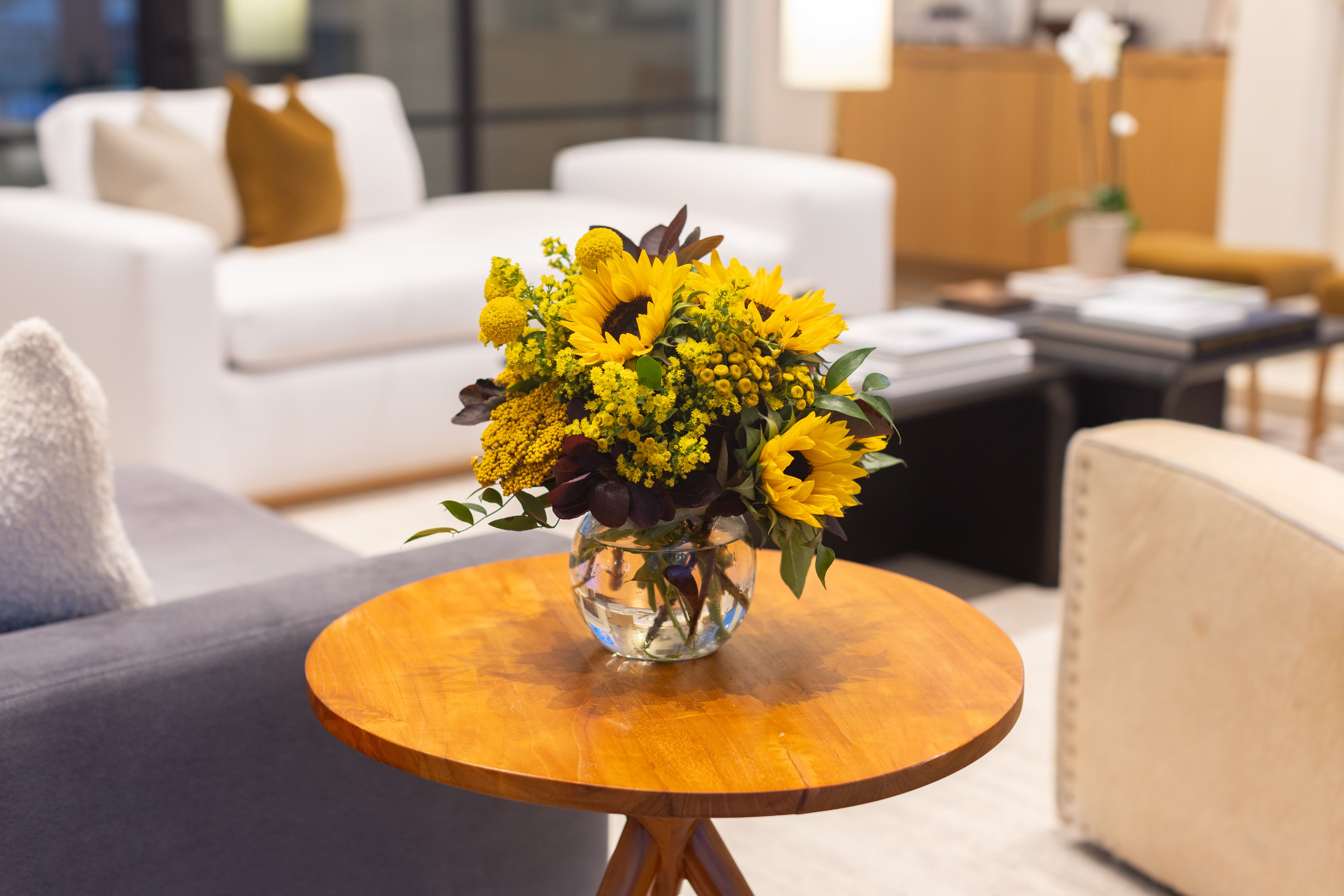 Fall Arrangement - A fresh floral arrangement with season tones and blooms. The perfect centerpiece for your next dinner party.   Need something smaller? Order the accent piece (Standard) perfect size for a side table or a great gift for the holidays. Deluxe is the most popular and will be built in a glass or ceramic vase.  The Premium will be built long and low in a compote vase or something similar. Perfect for a centerpiece.