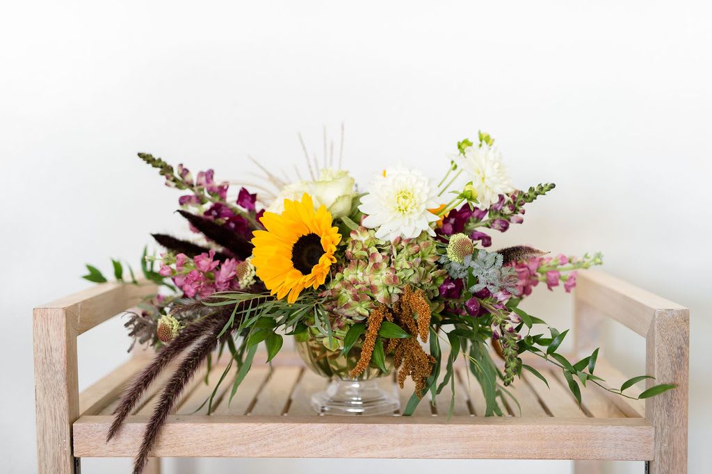 Long Centerpiece - This will be the star of the show at your thanksgiving lunch or dinner meal!  Please note that arrangements and bouquets Thanksgiving centerpieces are available for delivery or pickup between 9am + 12pm on November 27th in store!  Perfect size for: A Dining Room Table   *All flowers vary based on season and availability.*  Call us for special flower requests: 940.691.4444