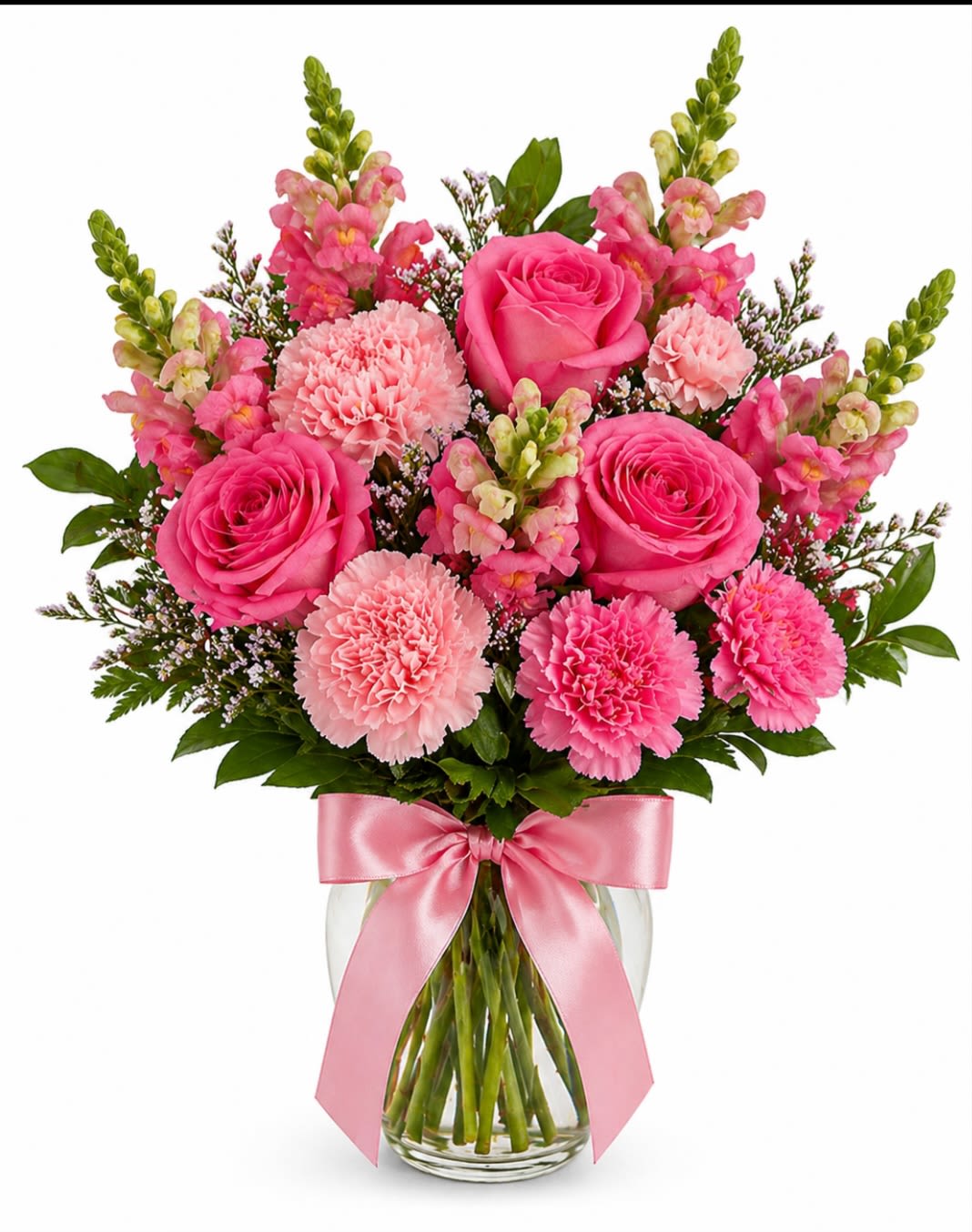 Sweet Elegance Bouquet  - A graceful everyday arrangement featuring premium pink roses, soft carnations and tall snap dragons accented with fresh greenery and delicate filler flowers. Designed in a clear glass vase and finished with a satin pink bow.