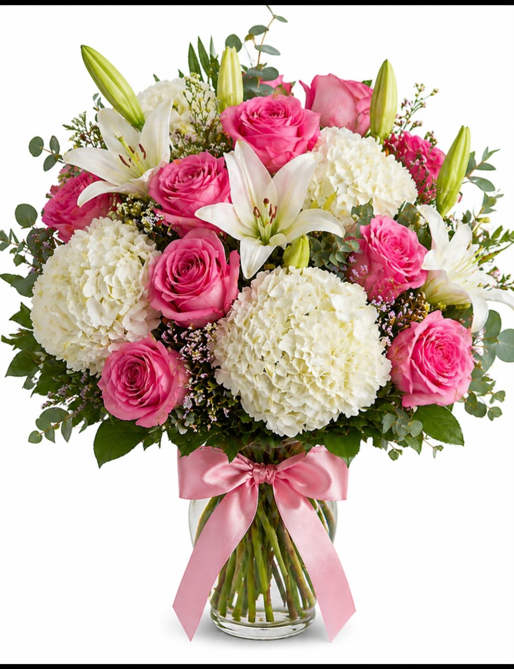 White Garden Elegance  - A luxurious every day arrangement featuring classic pink roses, crisp white hydrangeas,fragrant white lilies and fresh greenery  artfully arranged in a clear glass vase and finished with a satin pink bow.