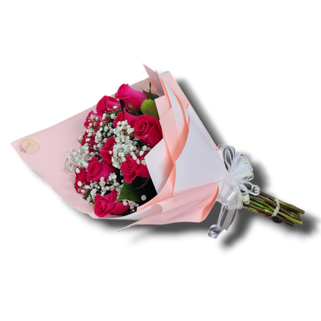 Bouquet of hot pink roses and white filler flowers wrapped in pink and white paper