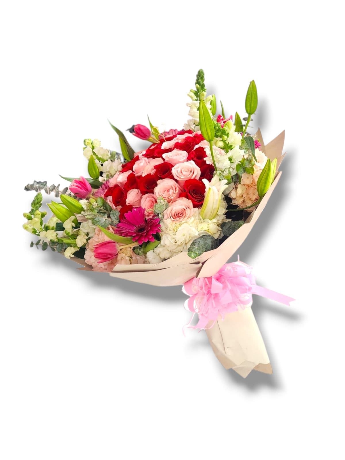 Bouquet of red and pink roses with lilies and white flowers in paper wrap