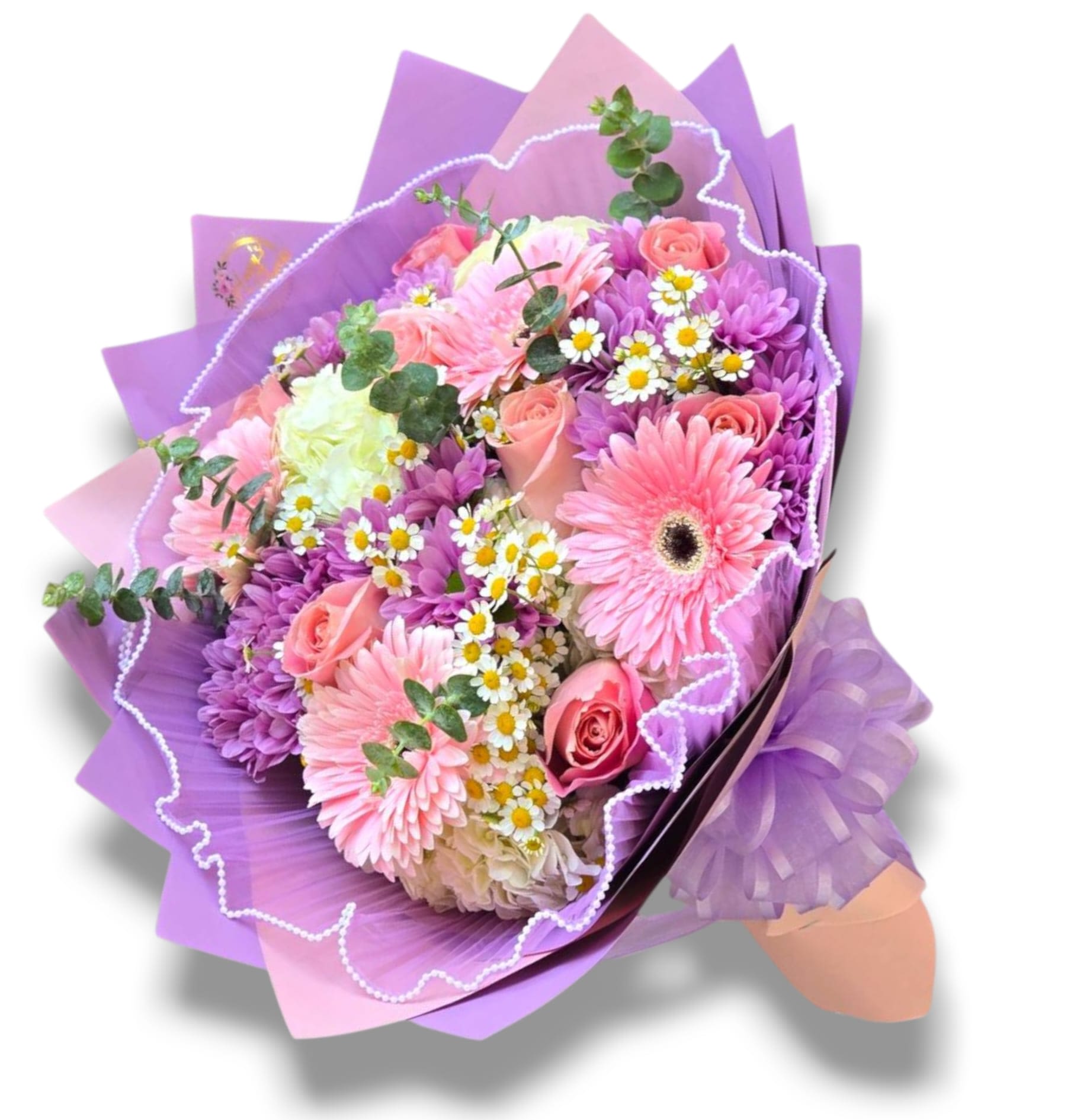 Pink and purple bouquet with roses and daisy-like flowers wrapped in purple paper