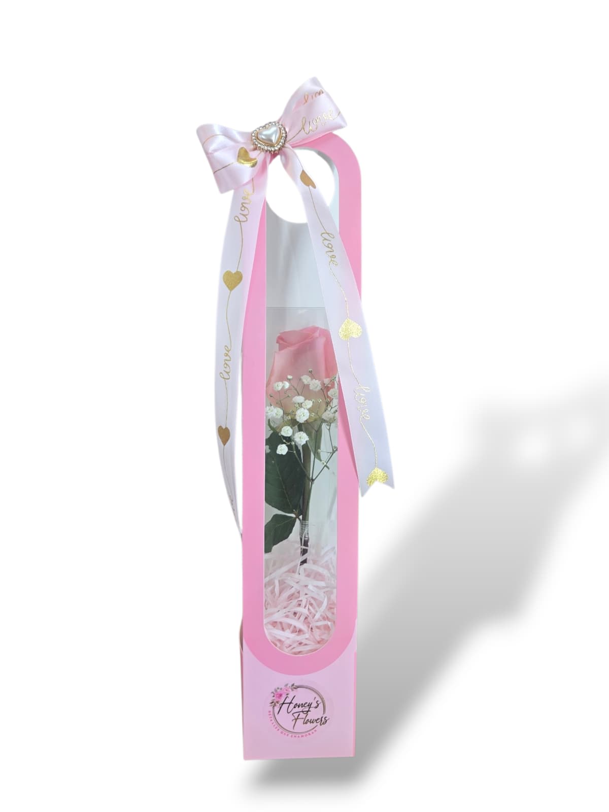 Single white rose in a pink gift box with a ribbon bow