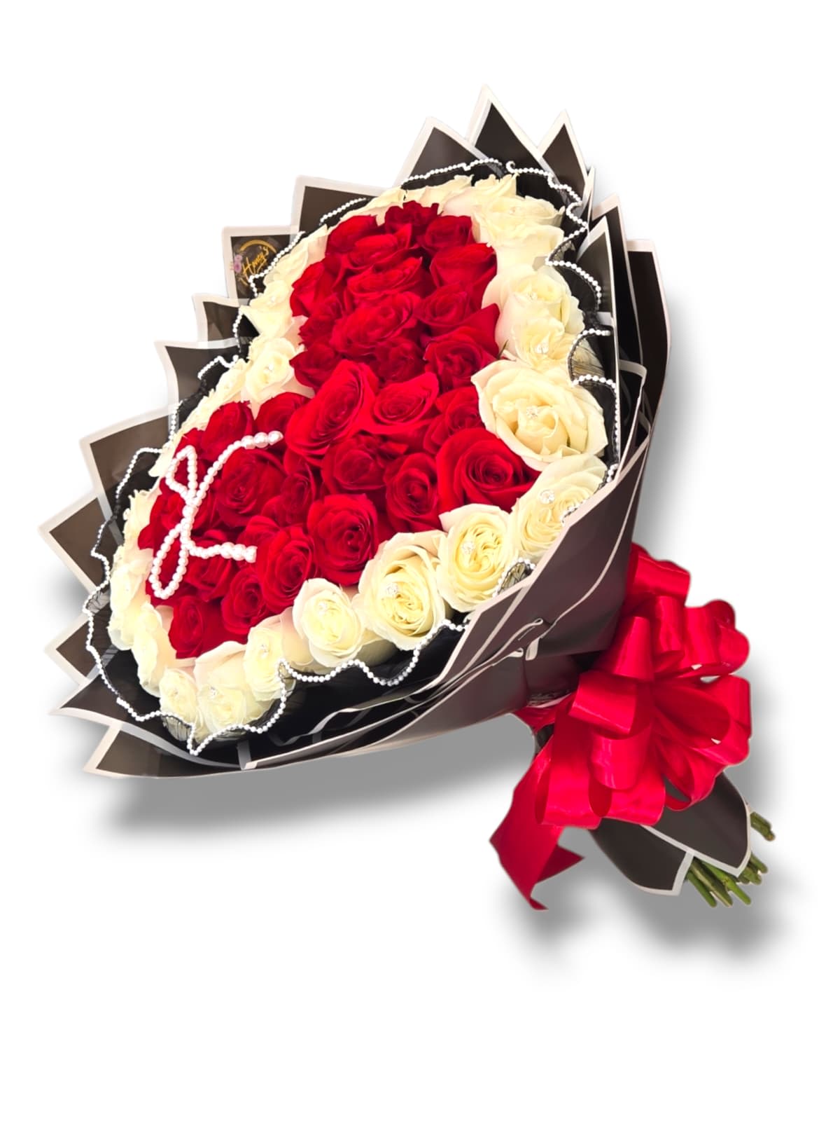 Bouquet of red and white roses wrapped in dark paper with a red ribbon