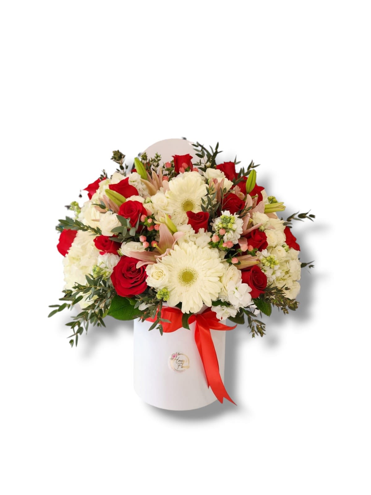 Red roses and white daisies in a white hatbox with a red ribbon