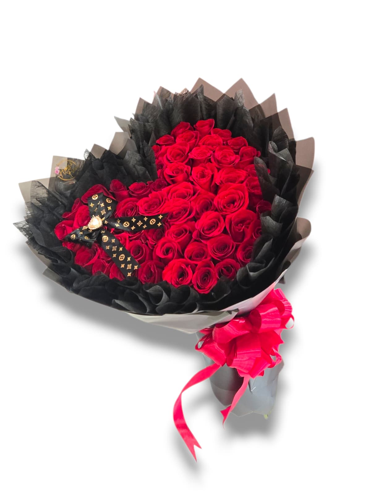 Bouquet of red roses wrapped in black paper with a pink ribbon