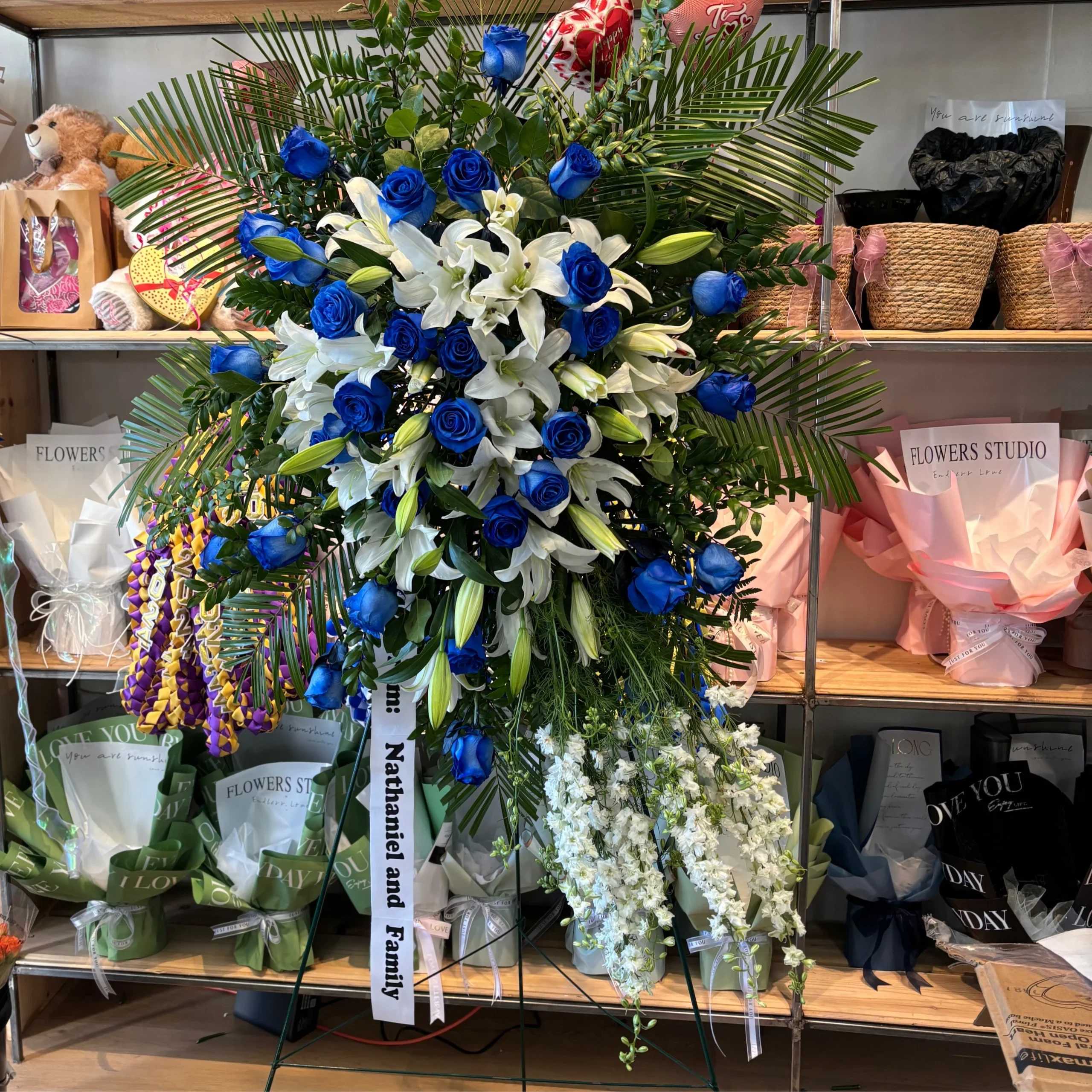 Large standing floral spray with blue roses and white lilies