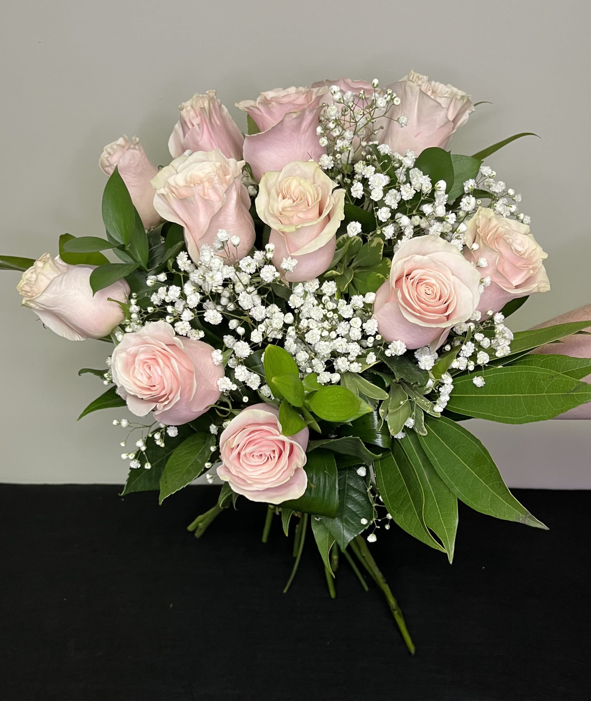 Wrapped Bouquet of Dozen Pink Roses by Chasing Petals - Wrapped bouquet of light pink roses with babies breath, ready to go in your favourite vase at home!