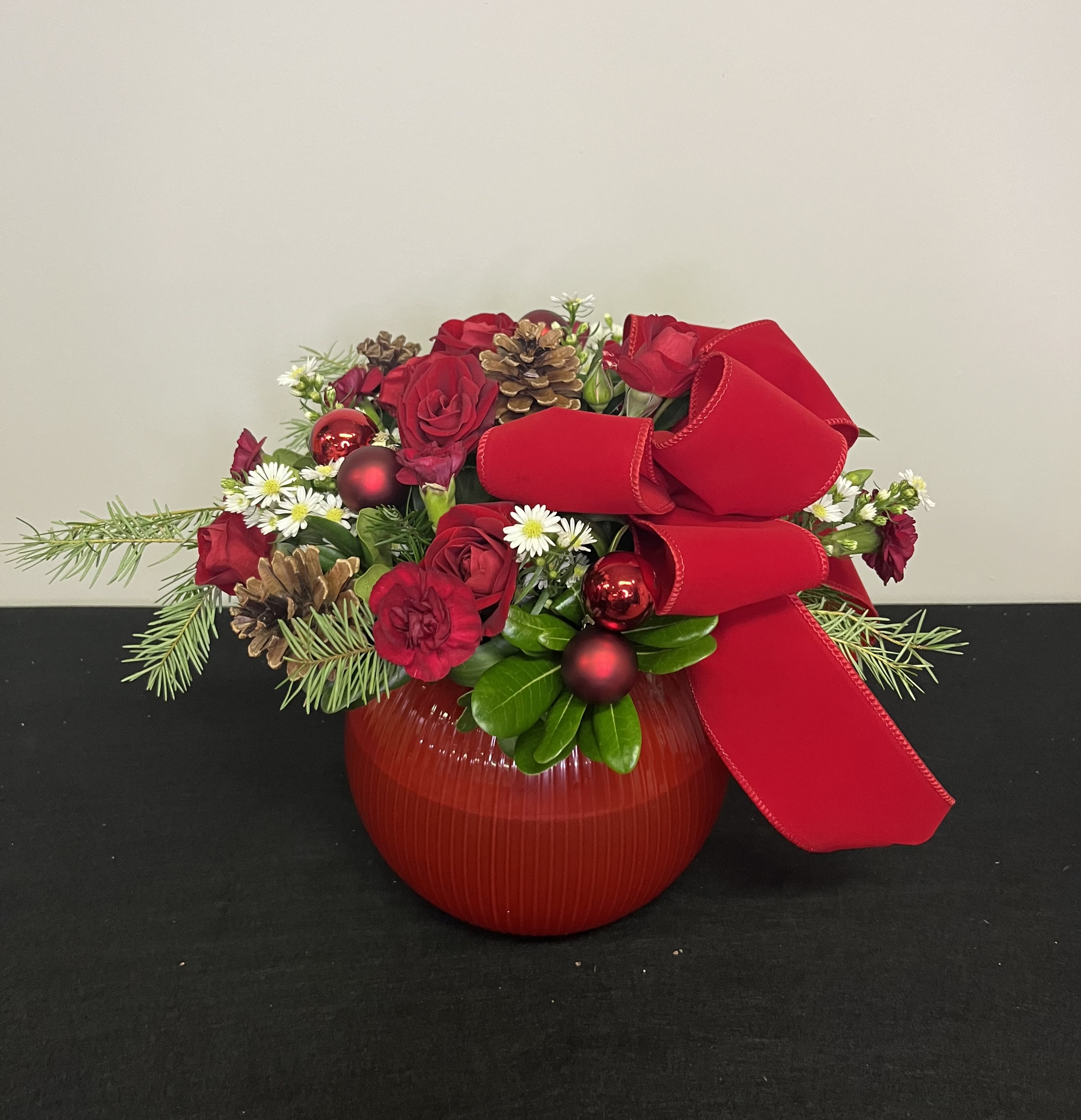 Wrapped in Red by Chasing Petals - A classic for the traditional Christmas lover! A Christmas red bubble bowl with elegant red bow and red flowers complimented by subtly fresh fragrant winter greens and a touch of white, perfect for any table large or small. 