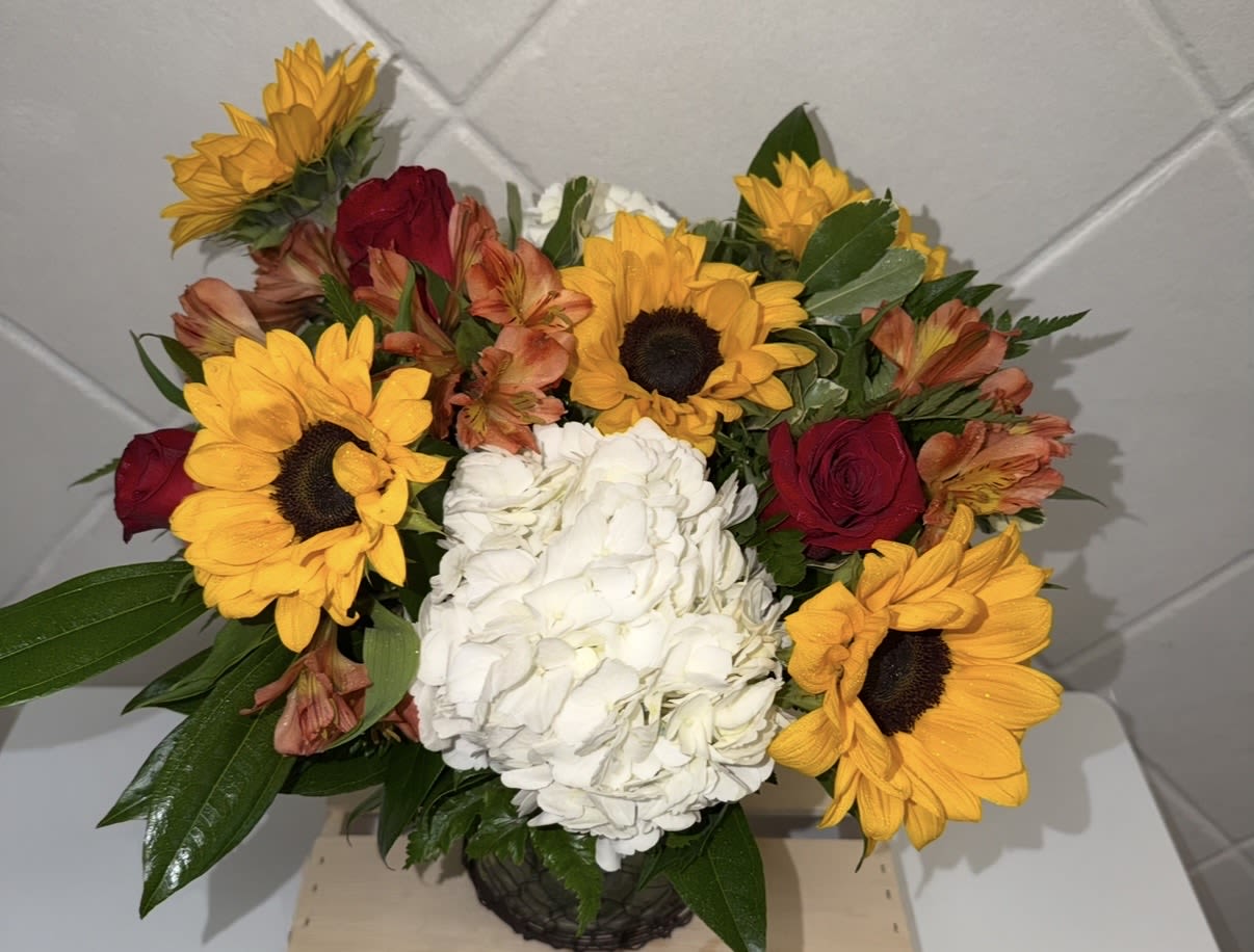 Monarch Garden - Bursting with the radiant hues of a Monarch in flight, this arrangement is a joyful dance of brilliant oranges and sunny golds. Each bloom feels alive with energy, like petals waiting for a Monarch to approach. 