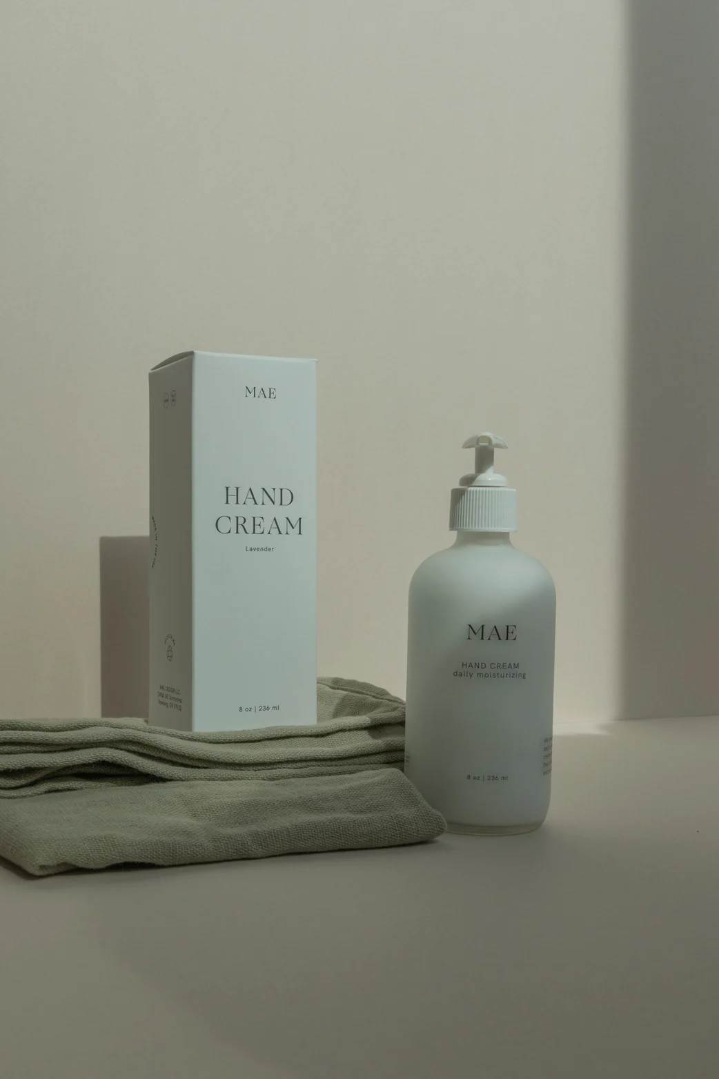 Hand cream bottle and box on folded cloth