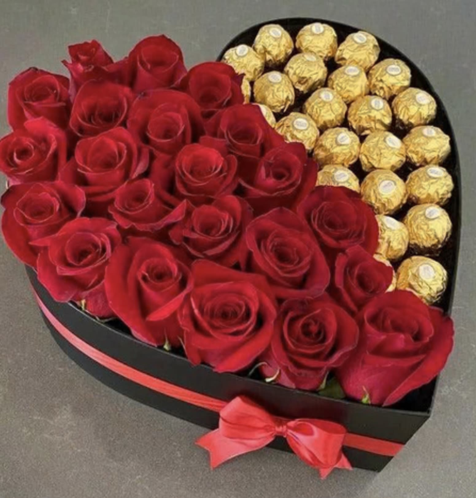 Heart-shaped box of red roses and gold-wrapped chocolates