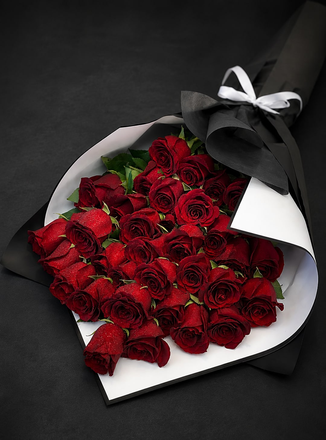 Long Roses same day delivery -  Scarlet Embrace – The Ultimate Symbol of Love   Nothing speaks of passion and romance like a bouquet of luxurious red roses. Scarlet Embrace is a breathtaking arrangement, elegantly wrapped in black and white, creating a striking contrast that enhances its beauty. This stunning bouquet is designed to leave a lasting impression on the one you love.   Perfect for:  Romantic surprises – Say “I love you” in the most timeless way.  Special occasions – Anniversaries, birthdays, or proposals.  Grand gestures – Because love deserves to be celebrated in style.  Make your moments unforgettable with Scarlet Embrace. Order now and let love bloom! ️