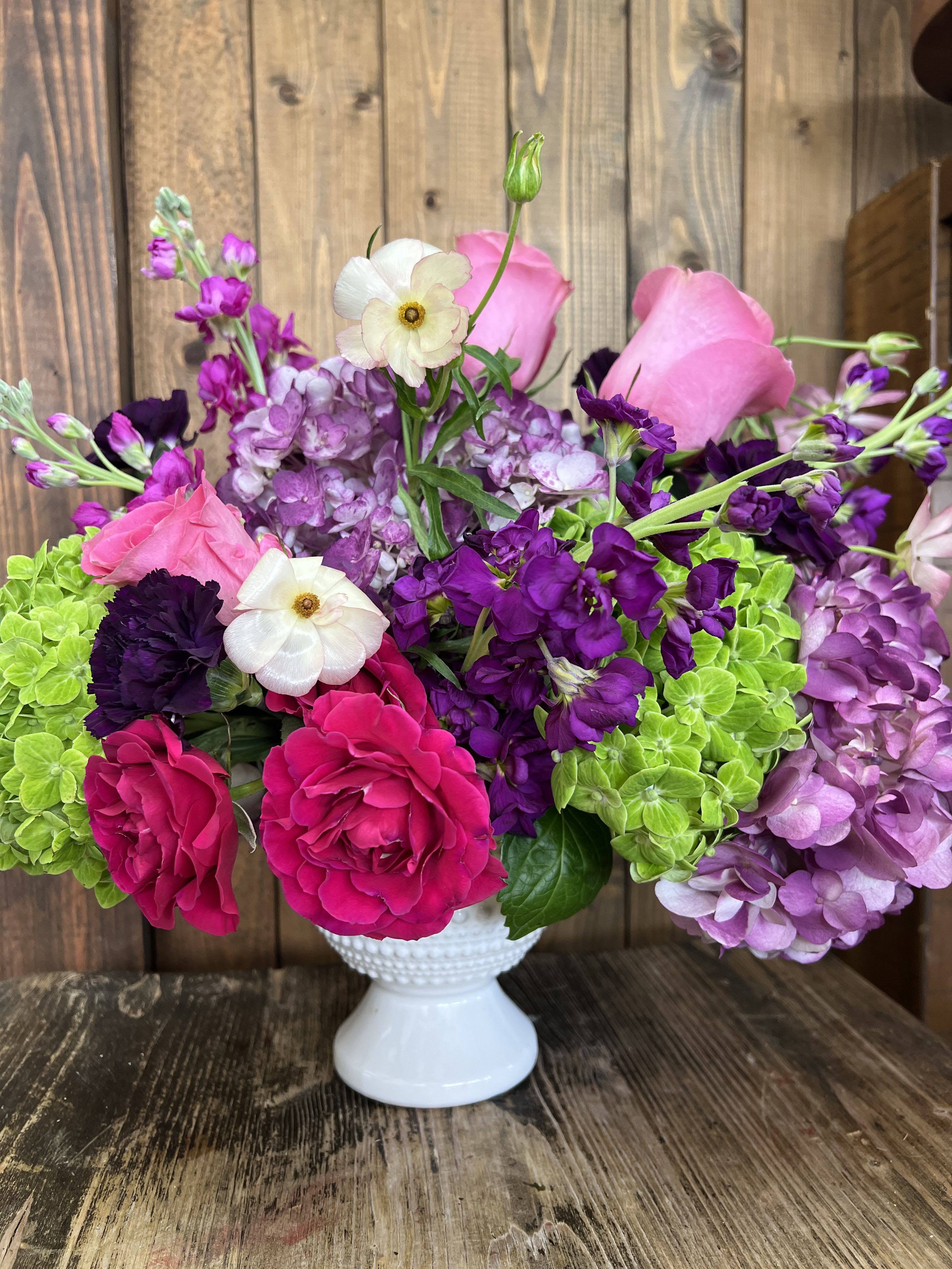 Pink and purple bouquet in a white vase