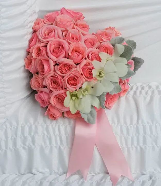 Pink rose bouquet with pale green orchids and a pink ribbon