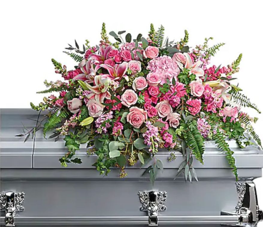 Pink floral casket spray with roses and lilies