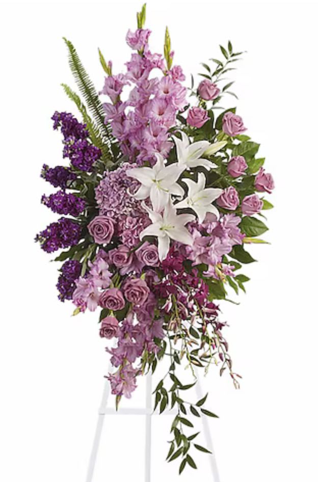 Lavender Reflections - Console and comfort with this luxurious spray of lavender roses, alstroemeria and gladioli. It's a majestic way to remember the departed at the memorial service.