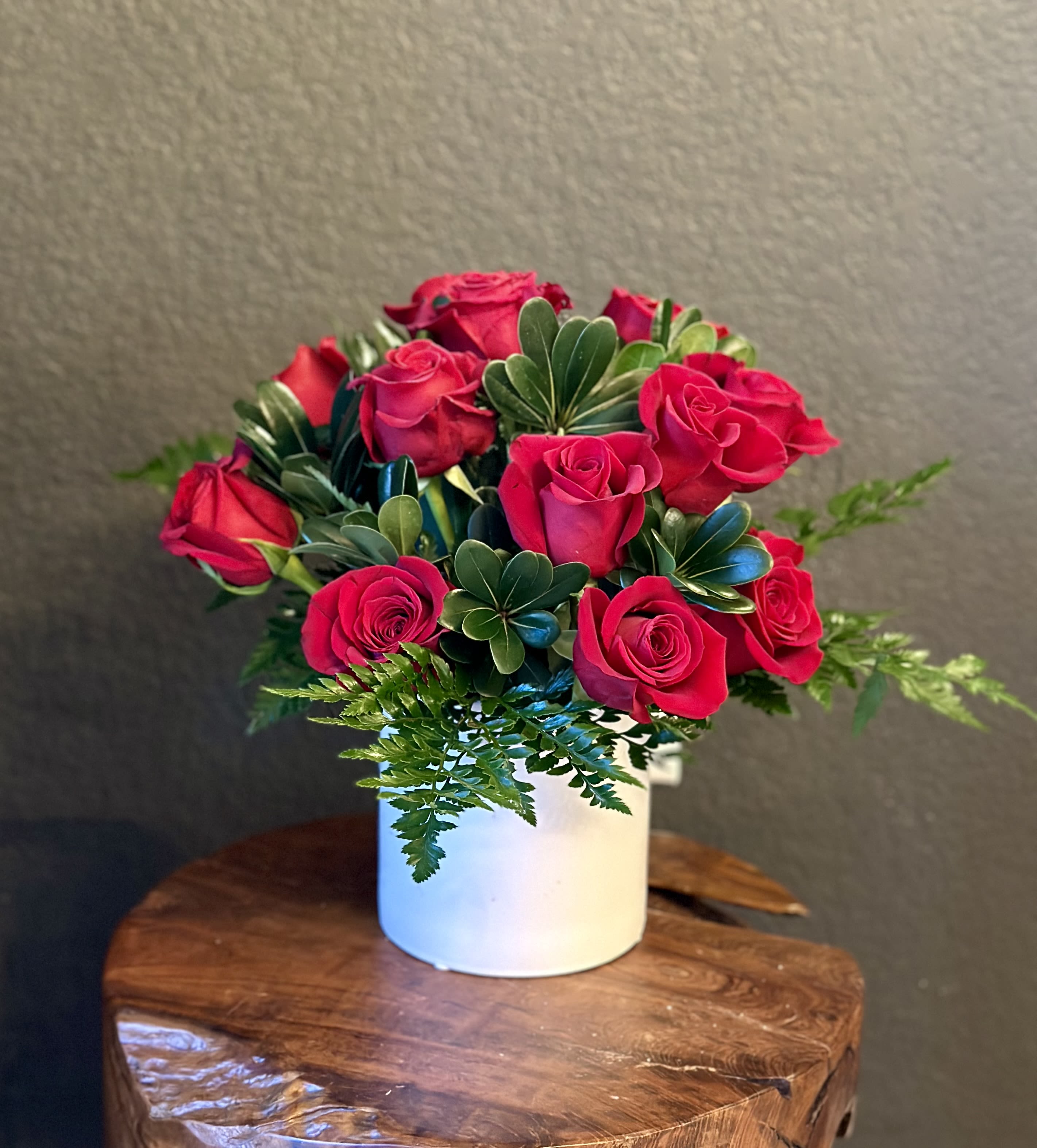 Bouquet of hot pink roses in a white vase