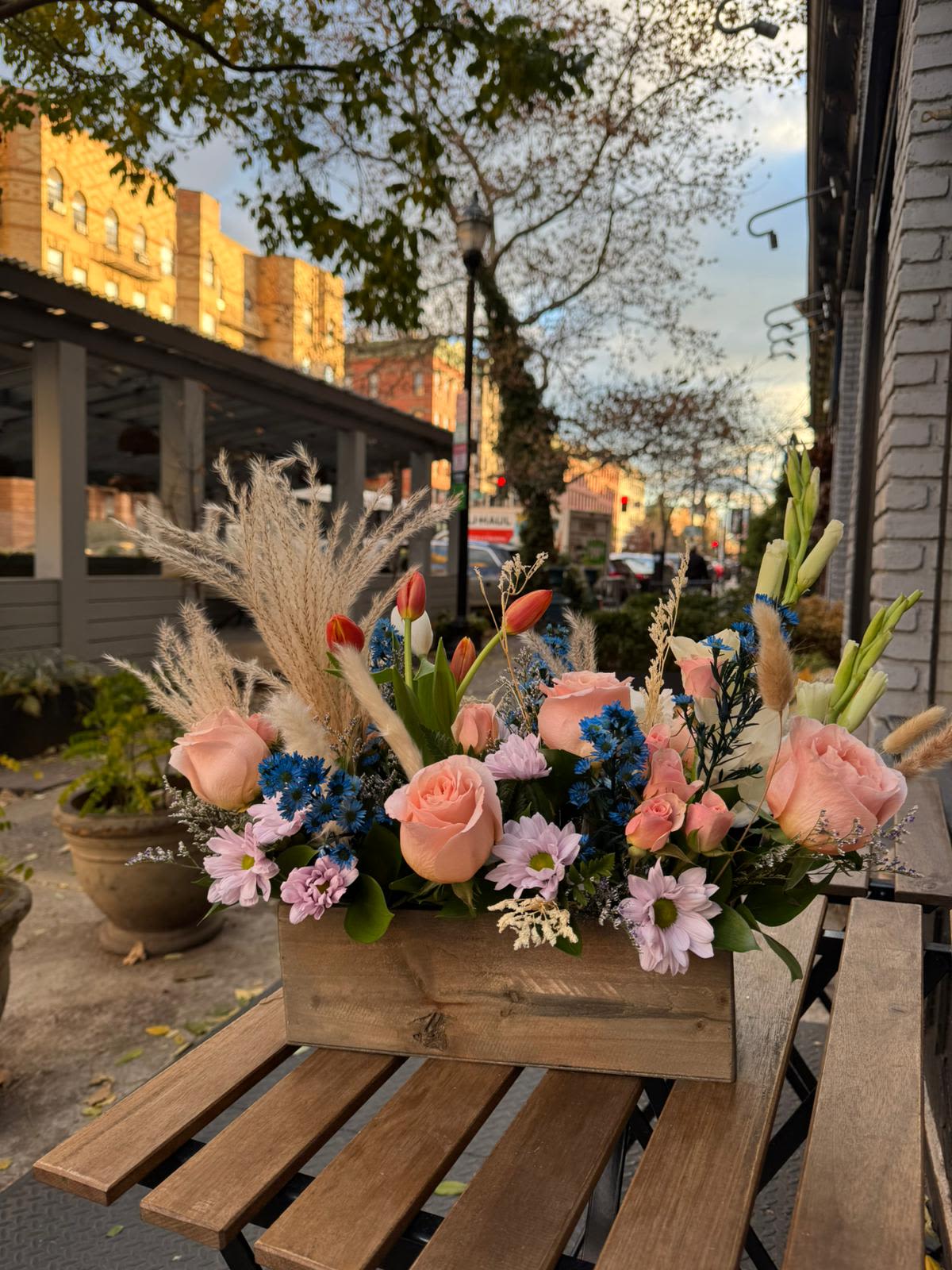 Wild and Free - A gift for your free-spirited, boho friend (crystals optional). This trendy arrangement is a mix of dried and fresh materials like bright pops of tulip and a sun palm. The perfect good vibes gift.  