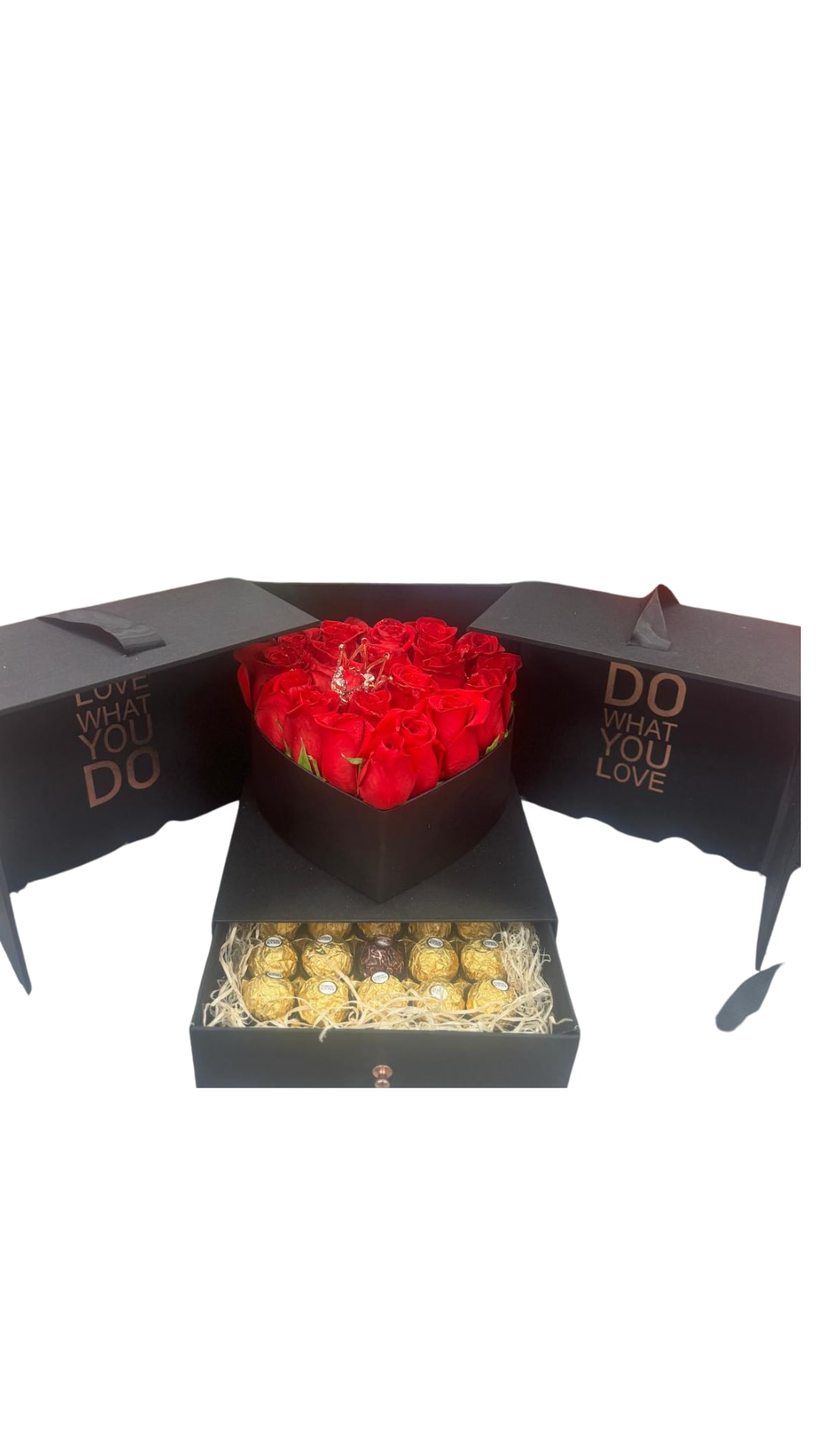 Red roses in a black heart-shaped box with chocolates in a drawer below.