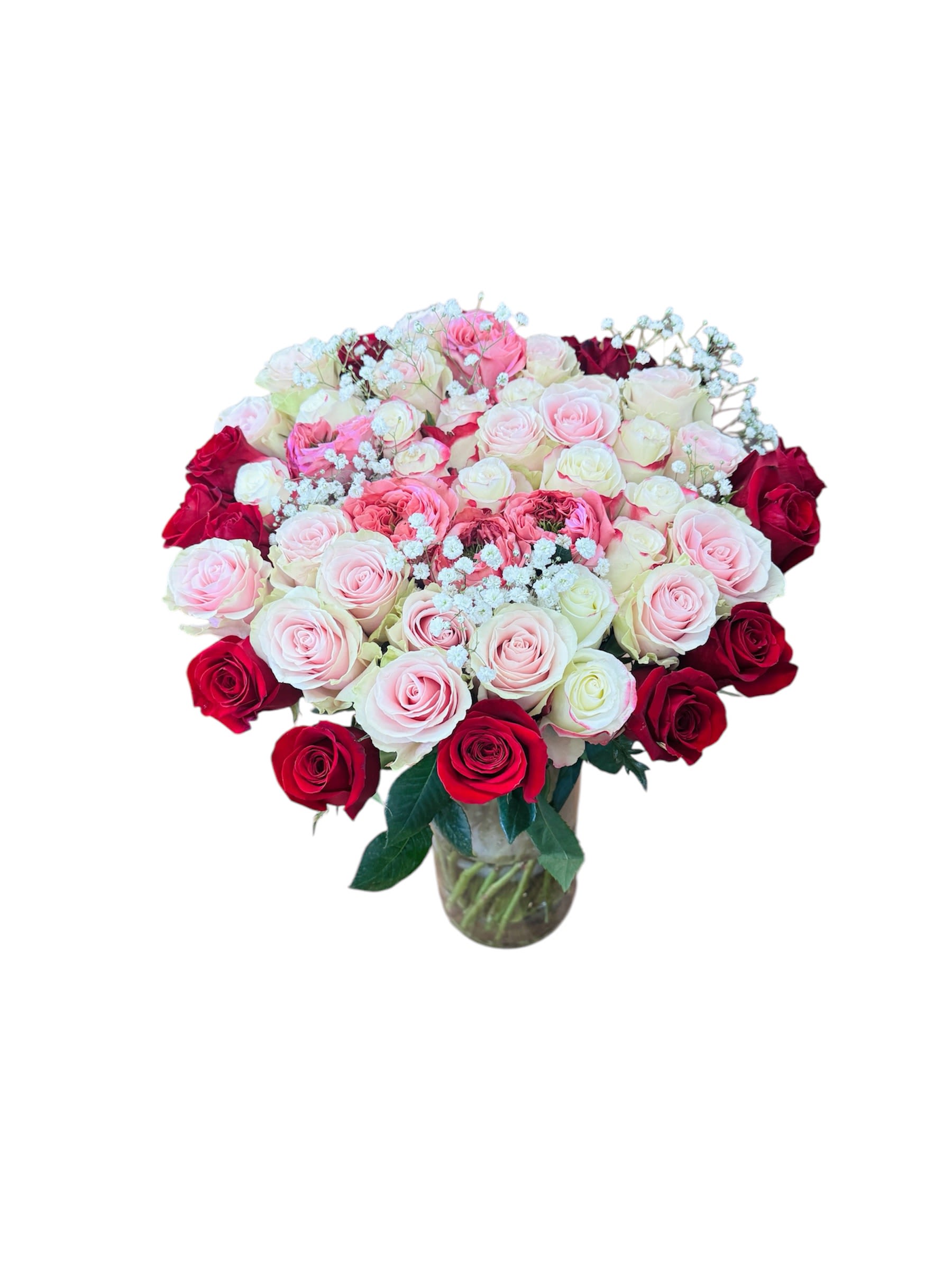 Large mixed pink, white, and red rose arrangement in a clear glass vase