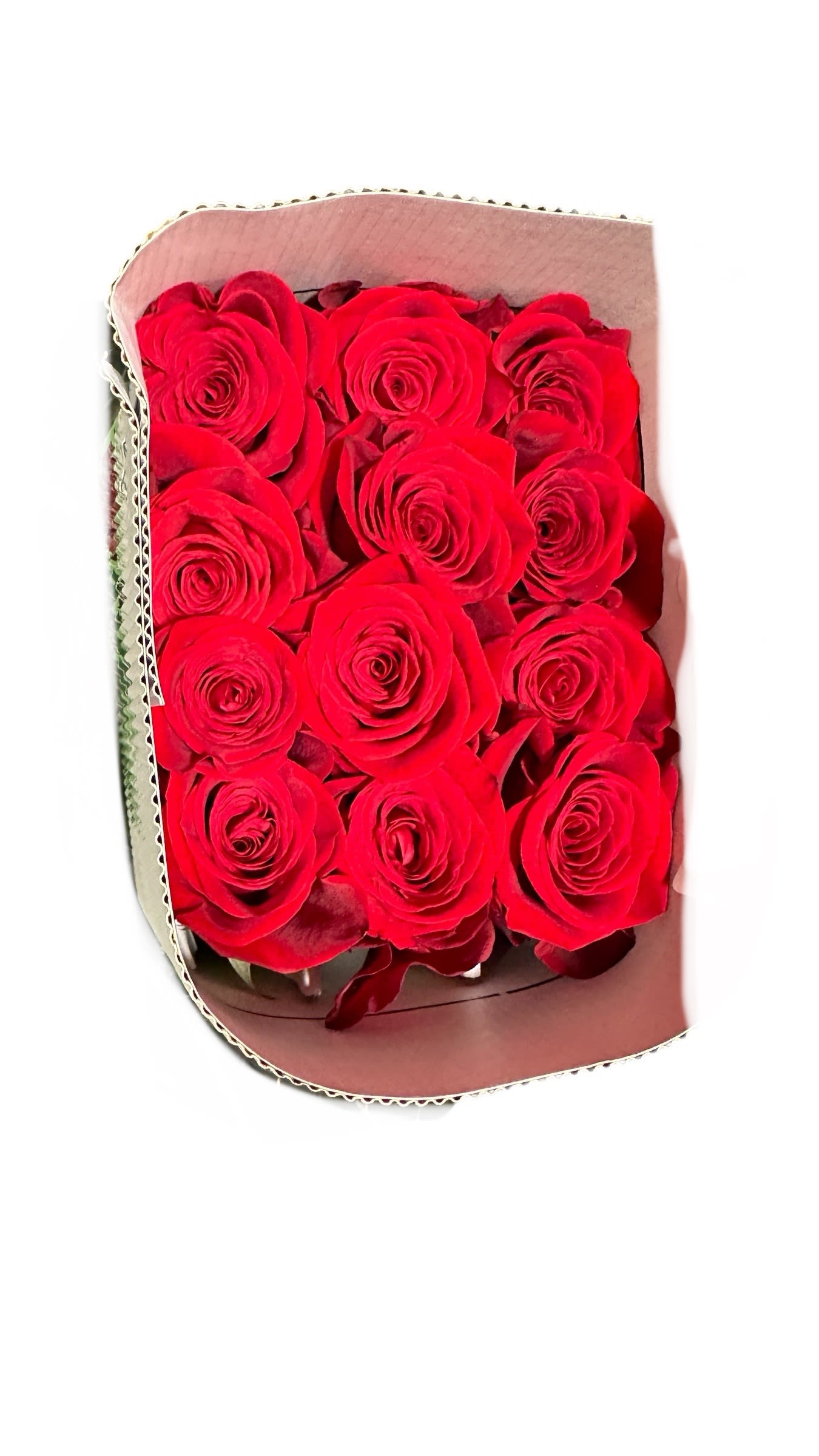 Bouquet of red roses wrapped in pale paper