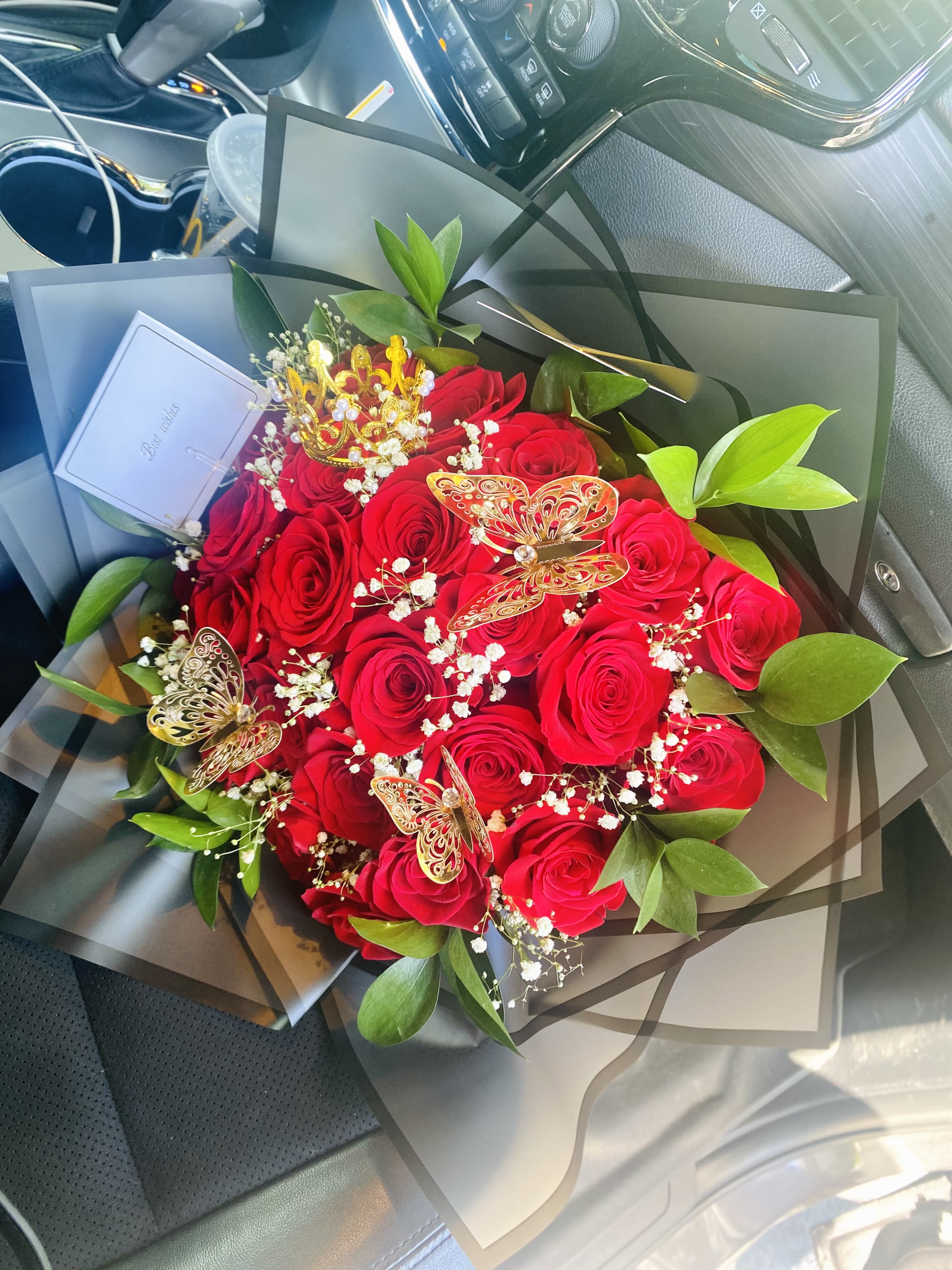 Bouquet of red roses with baby’s breath and butterfly picks