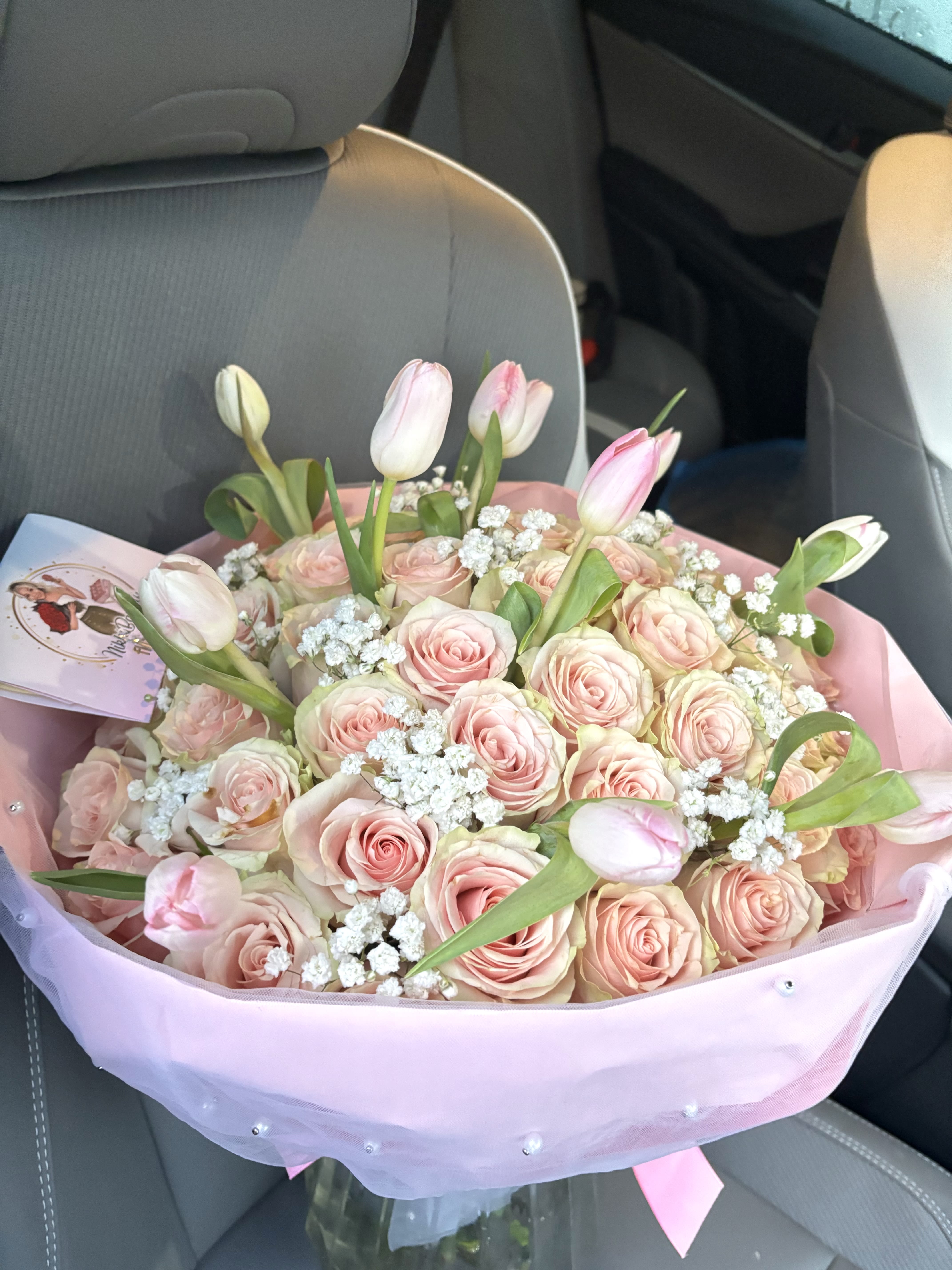 Pink rose and tulip bouquet wrapped in pastel paper