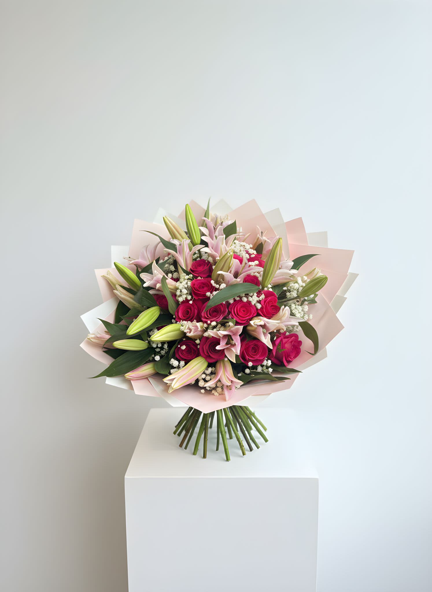 Hot Pink Rose &amp; Lily Garden Bouquet - Our Blush Garden Luxury Bouquet is a stunning, full arrangement featuring a beautiful mix of pink lilies, vibrant roses, baby’s breath, and lush greenery, wrapped in soft blush-toned premium paper for an elegant finish.  Designed to make a statement, this bouquet is perfect for birthdays, anniversaries, celebrations, or just because. Its lush, garden-inspired style brings softness, romance, and luxury into any moment.  Each bouquet is handcrafted with care to ensure fullness and balance.  Please note: Flower tones and bloom stages may vary. Lilies may arrive in bud form for longer-lasting freshness.